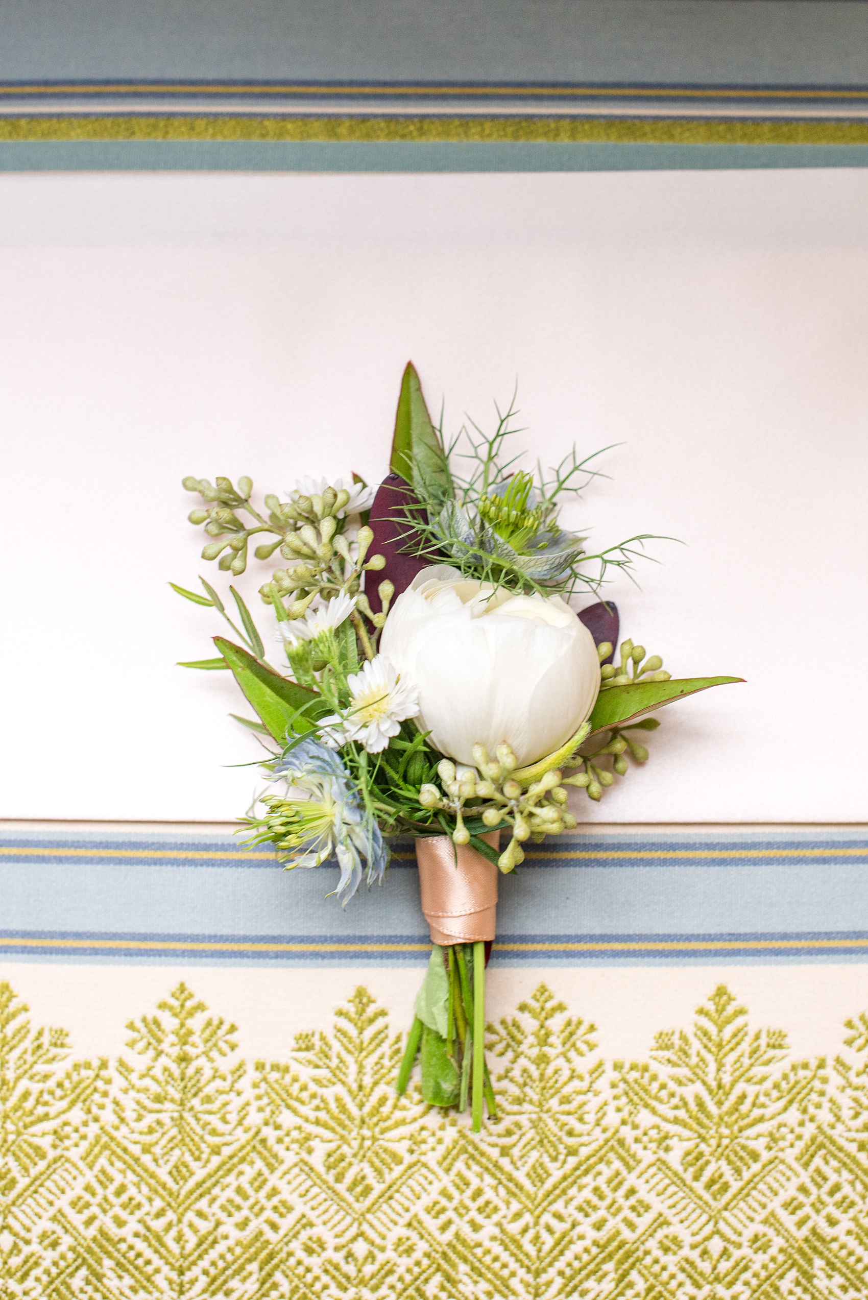 Beautiful wedding photos at The Carolina Inn at Chapel Hill, North Carolina by Mikkel Paige Photography. Detail photo of the ranunculus winter boutonniere. Click through to see the rest of this gorgeous winter wedding! #thecarolinainn #snowywedding