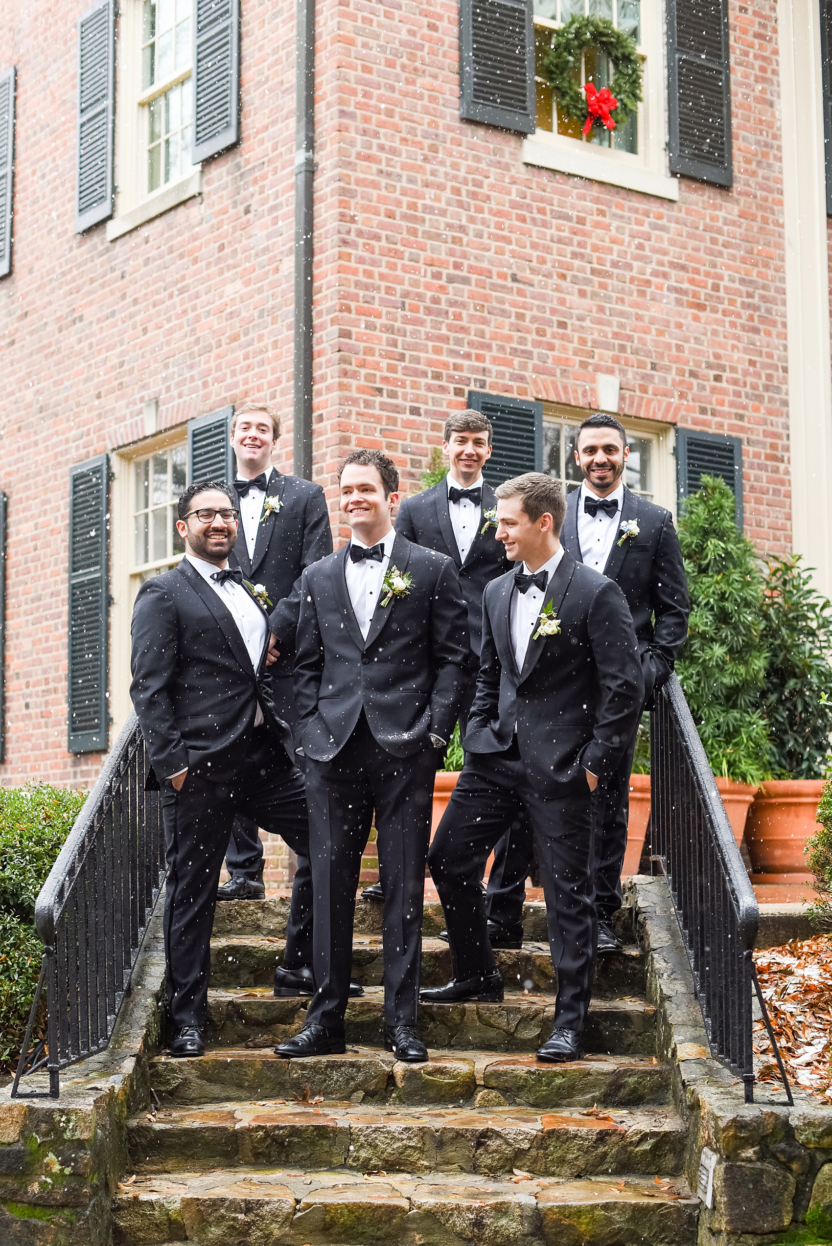 Beautiful wedding photos at The Carolina Inn at Chapel Hill, North Carolina by Mikkel Paige Photography. Photo of the groomsmen in the snow in classic black tuxedos and bow ties. Click through to see the rest of this gorgeous winter wedding! #thecarolinainn #snowywedding