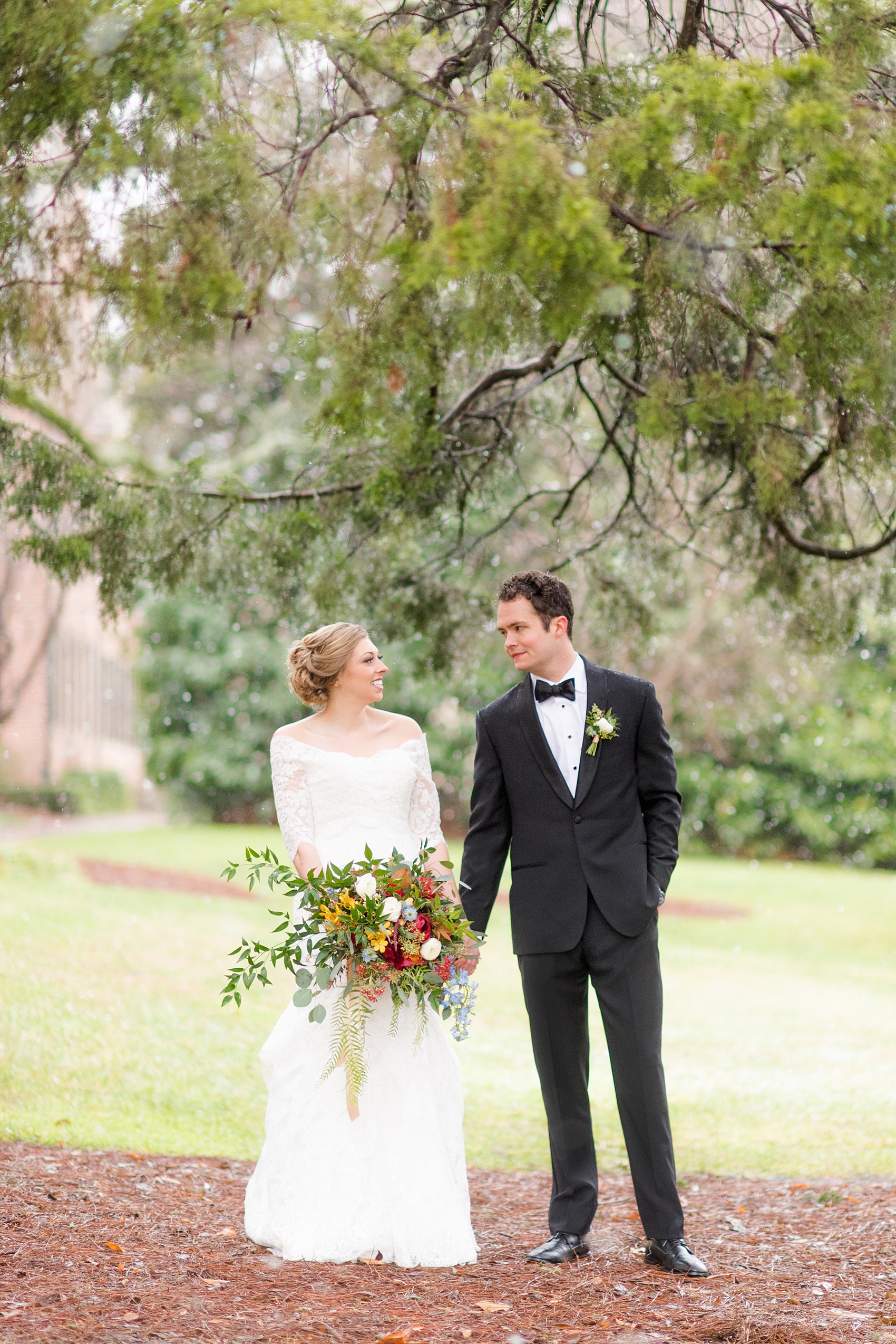 Beautiful wedding photos at The Carolina Inn at Chapel Hill, North Carolina by Mikkel Paige Photography. Photo of the bride and groom's winter wedding, enjoying the moments by an evergreen tree at this southern venue. Click through to see the rest of this gorgeous winter wedding! #thecarolinainn #snowywedding