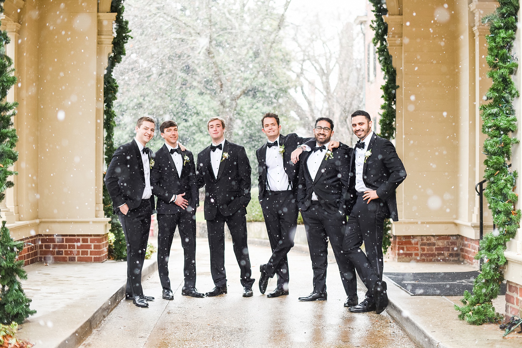 Beautiful wedding photos at The Carolina Inn at Chapel Hill, North Carolina by Mikkel Paige Photography. Photo of the groomsmen in the snow in classic black tuxedos and bow ties. Click through to see the rest of this gorgeous winter wedding! #thecarolinainn #snowywedding