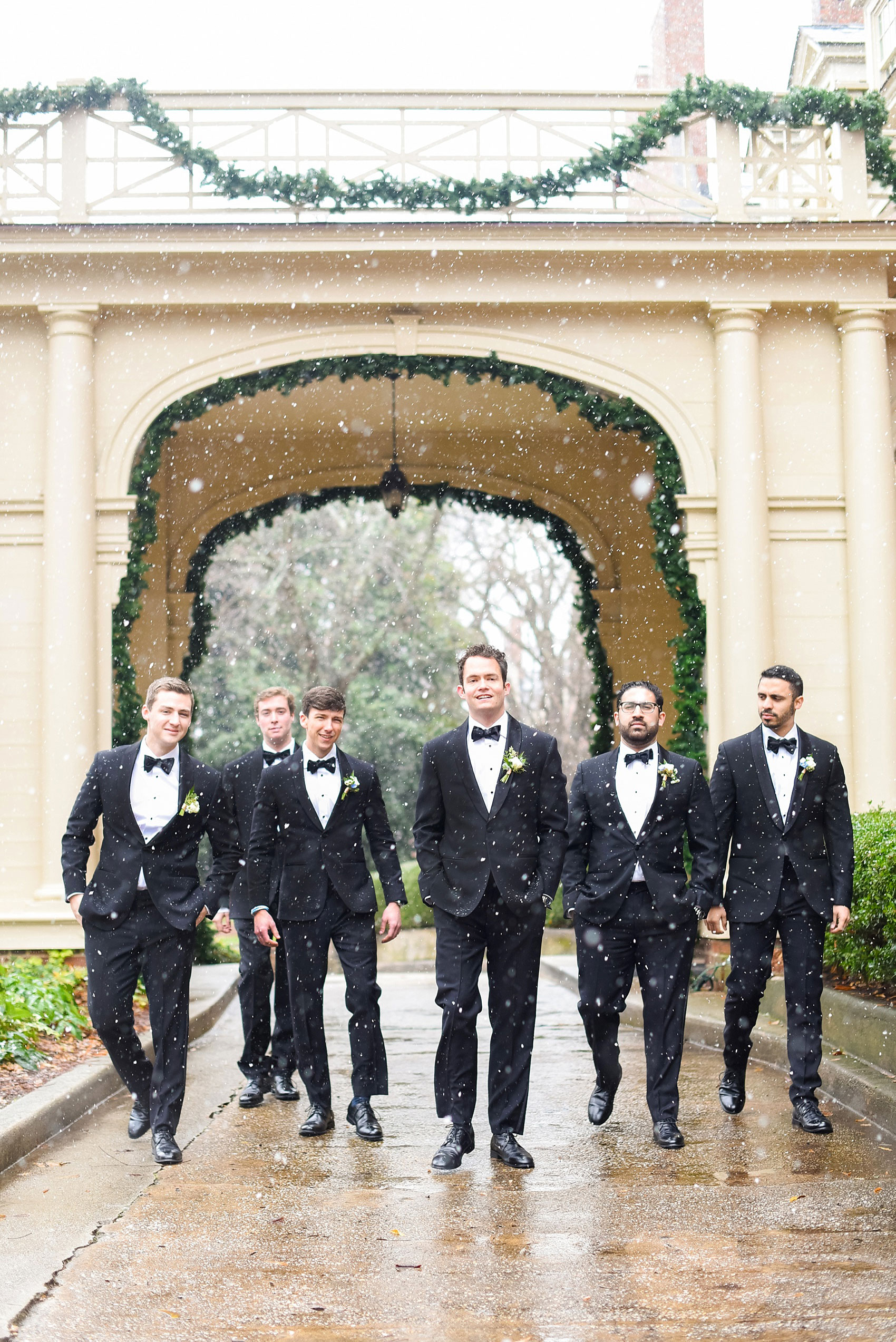 Beautiful wedding photos at The Carolina Inn at Chapel Hill, North Carolina by Mikkel Paige Photography. Photo of the groomsmen walking in the snow in classic black tuxedos and bow ties. Click through to see the rest of this gorgeous winter wedding! #thecarolinainn #snowywedding