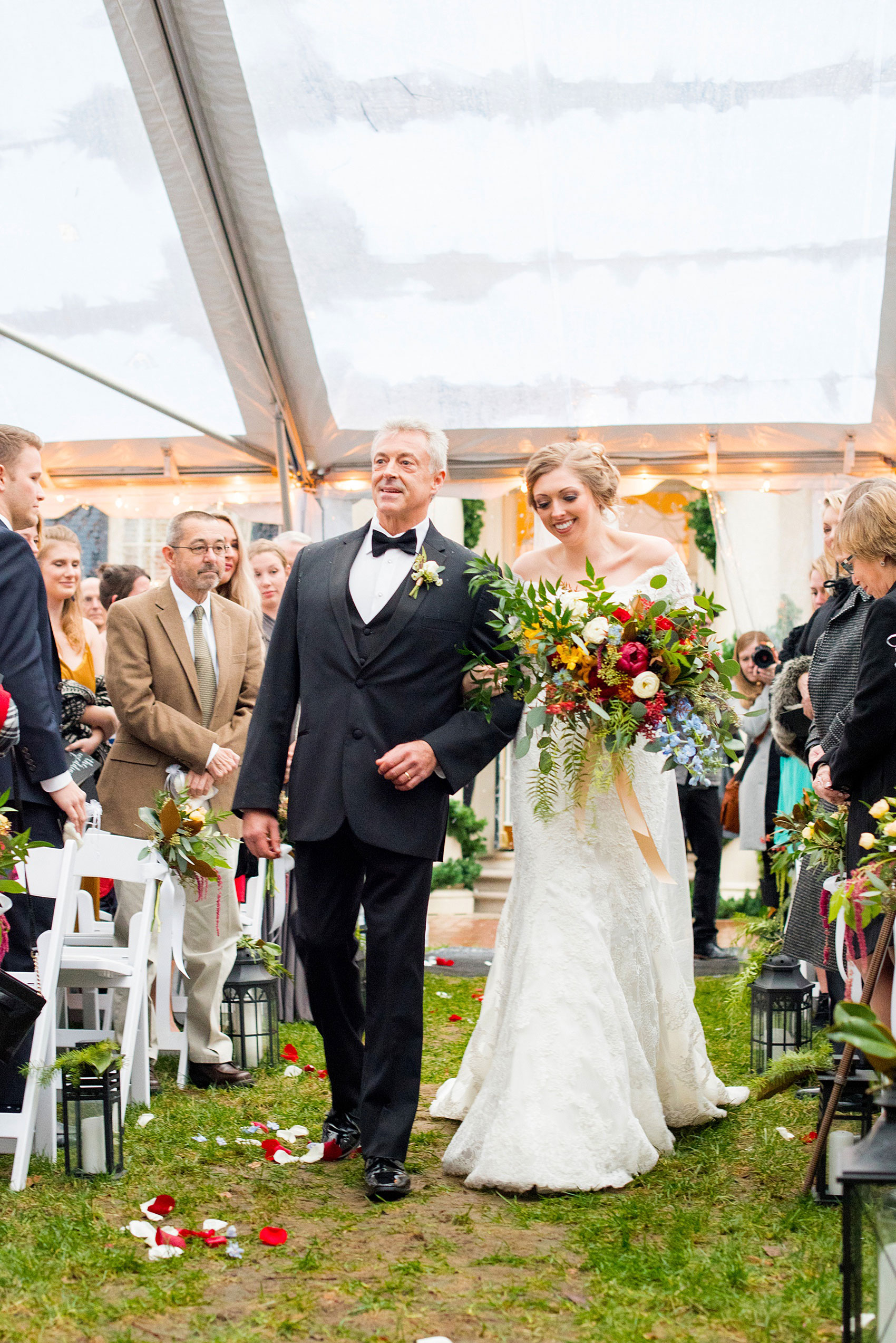 Beautiful wedding photos at The Carolina Inn at Chapel Hill, North Carolina by Mikkel Paige Photography. Ceremony photo of the bride walking down the aisle with her father under a clear tent. Planning by McLean Events. Click through to see the rest of this gorgeous winter wedding! #thecarolinainn #snowywedding