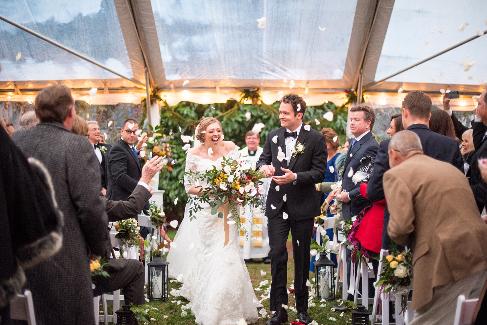 Beautiful wedding photos at The Carolina Inn at Chapel Hill, North Carolina by Mikkel Paige Photography. Picture of the outdoor ceremony under a clear tent with a white rose petal toss exit. Click through to see the rest of this gorgeous winter wedding! #thecarolinainn #snowywedding