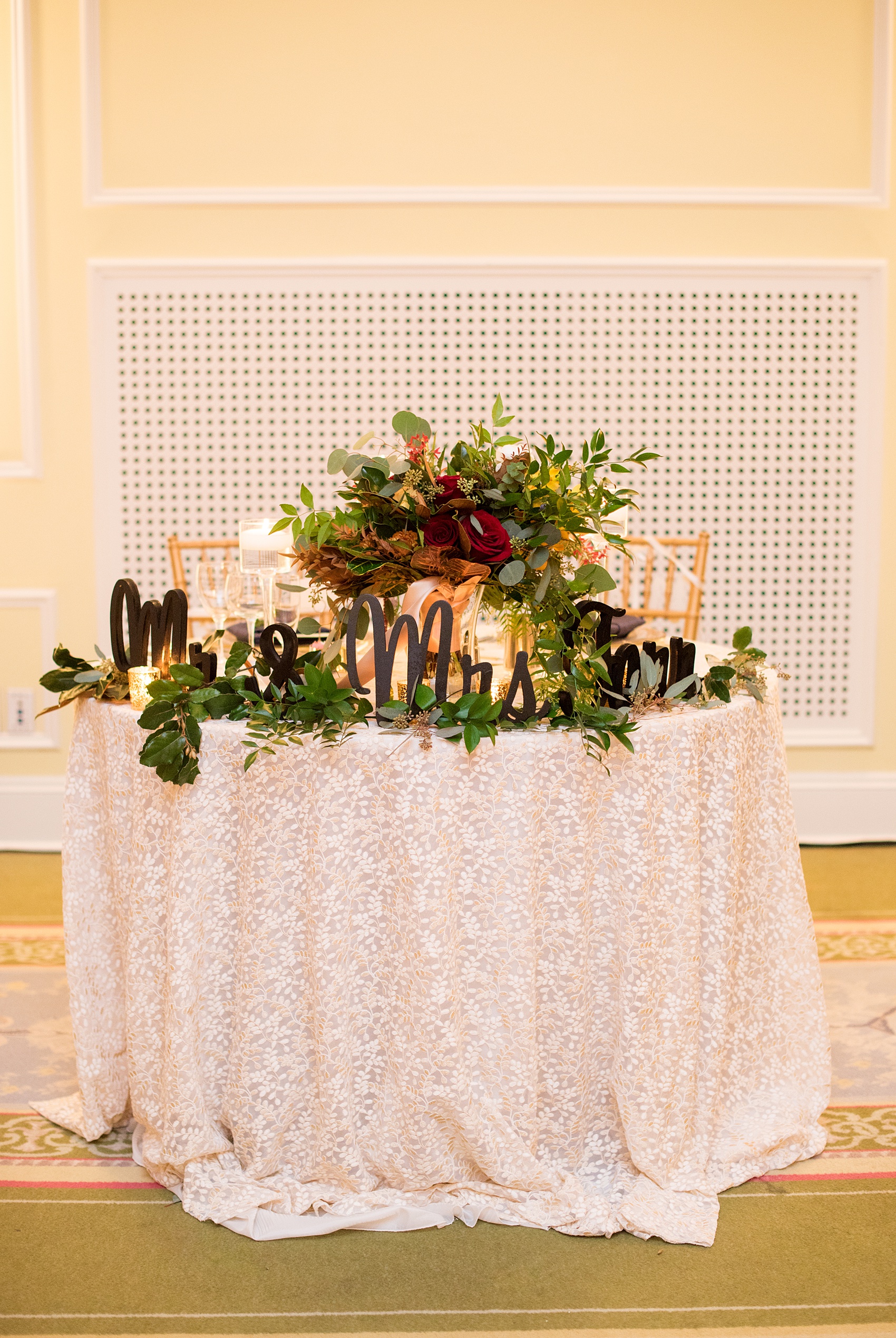 Beautiful wedding photos at The Carolina Inn at Chapel Hill, North Carolina by Mikkel Paige Photography. Picture of the bride and groom's sweetheart table with a script sign of their new last name. Click through to see the rest of this gorgeous winter wedding! #thecarolinainn #snowywedding