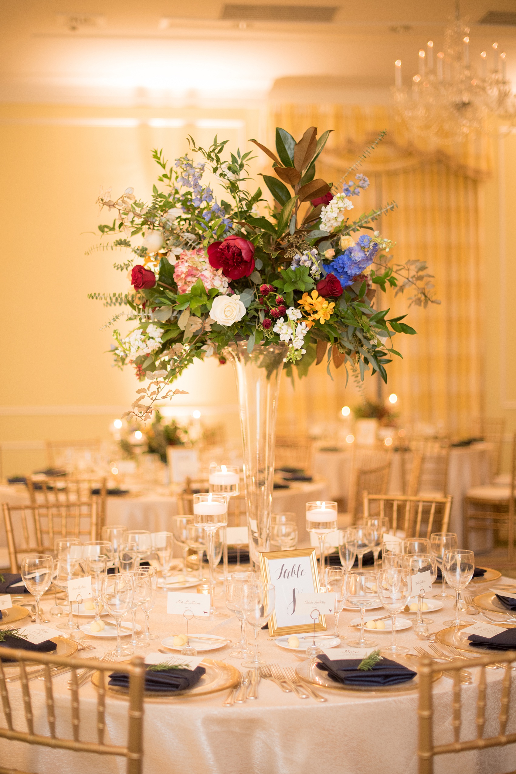 Beautiful wedding photos at The Carolina Inn at Chapel Hill, North Carolina by Mikkel Paige Photography. Picture of the ballroom with high and low centerpieces and gold and navy color palette. Click through to see the rest of this gorgeous winter wedding! #thecarolinainn #snowywedding