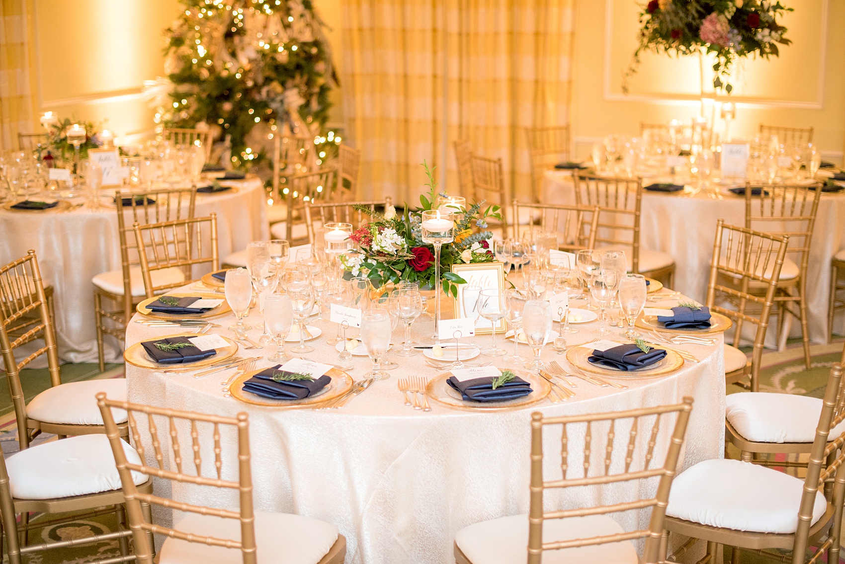 Beautiful wedding photos at The Carolina Inn at Chapel Hill, North Carolina by Mikkel Paige Photography. Picture of the ballroom with high and low centerpieces and gold and navy color palette. Click through to see the rest of this gorgeous winter wedding! #thecarolinainn #snowywedding