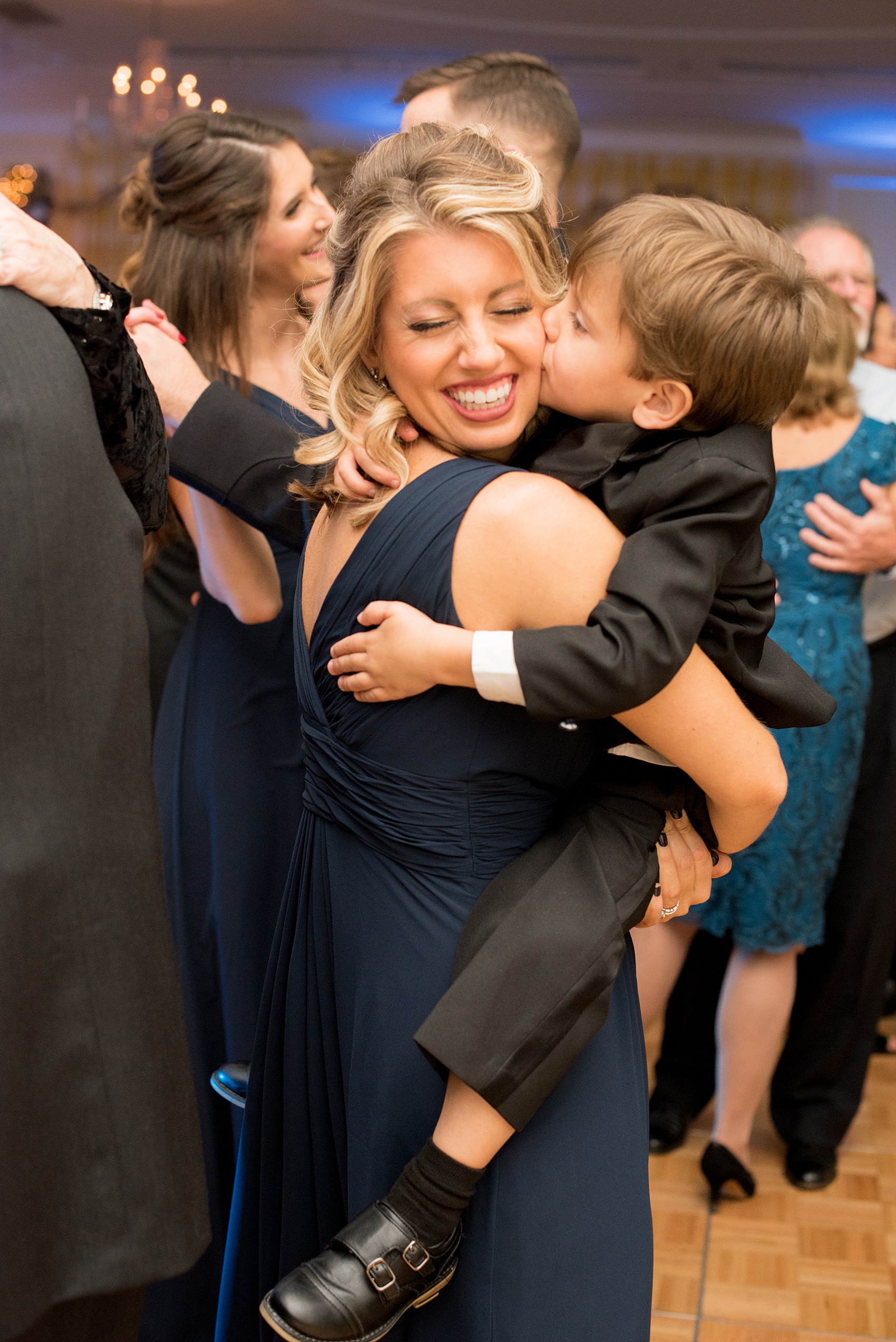 Beautiful wedding photos at The Carolina Inn at Chapel Hill, North Carolina by Mikkel Paige Photography. Picture of the maid of honor in a navy gown with her son, the ring bearer. Click through to see the rest of this gorgeous winter wedding! #thecarolinainn #snowywedding