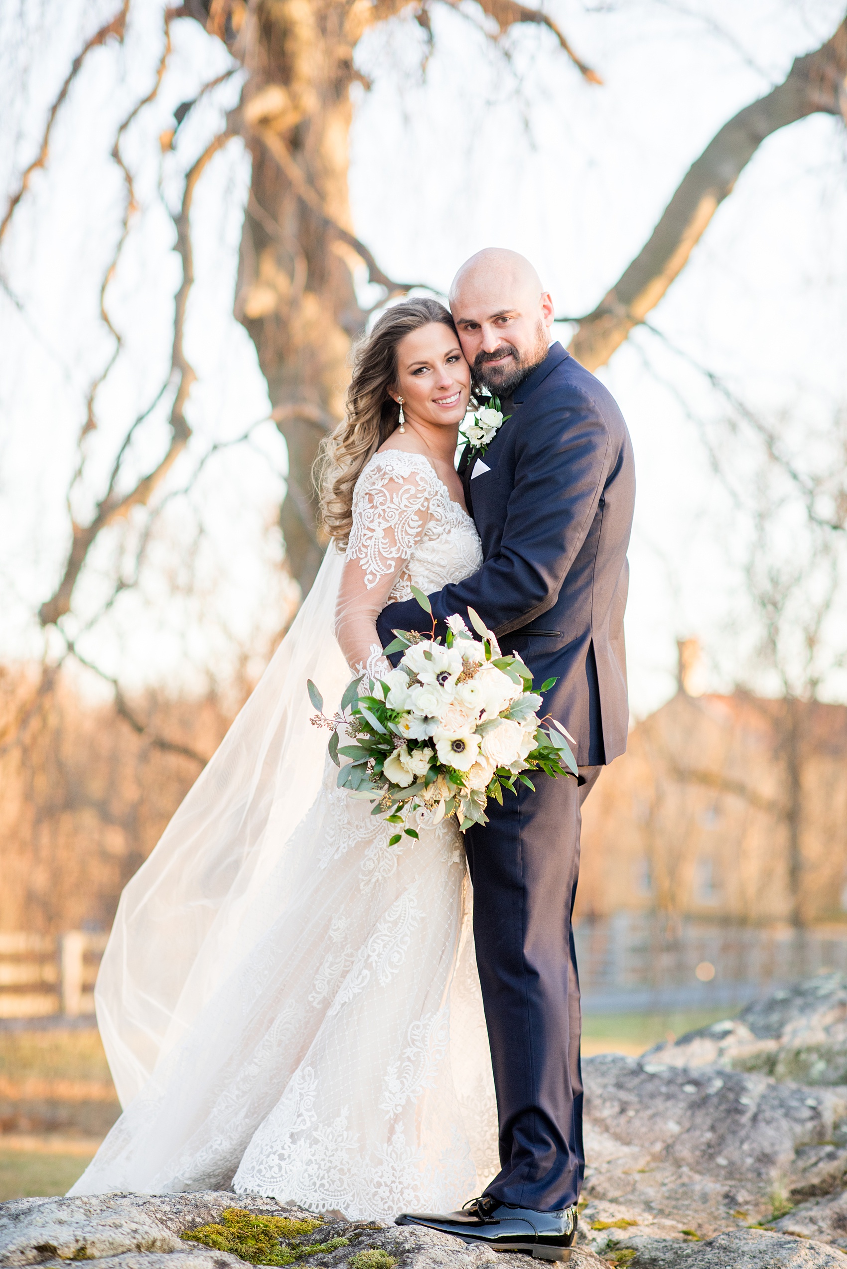 Winter wedding photos at Sleepy Hollow Country Club, New York about an hour from NYC, by Mikkel Paige Photography. The bride wore a long sleeve lace gown and the groom wore a navy blue suit with a black lapel. #winterwedding #NYweddingphotos #SleepyHollowNY