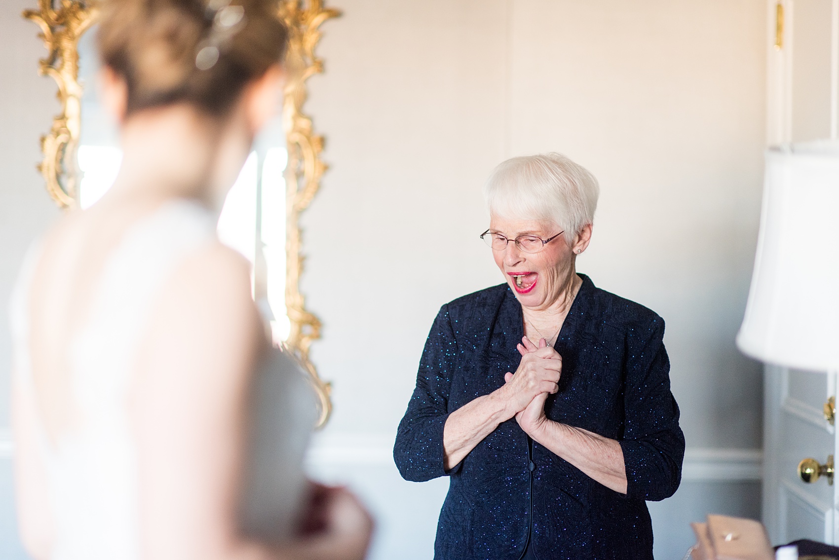 Photos by Mikkel Paige Photography of a Central Park Wedding ceremony and reception at the Loeb Boathouse venue with a romantic theme. Picture of the bride's mother seeing her for the first time that winter day inside the Park Lane Hotel before her first look with her groom. Click through for more images from their winter wedding day! #CentralParkWedding