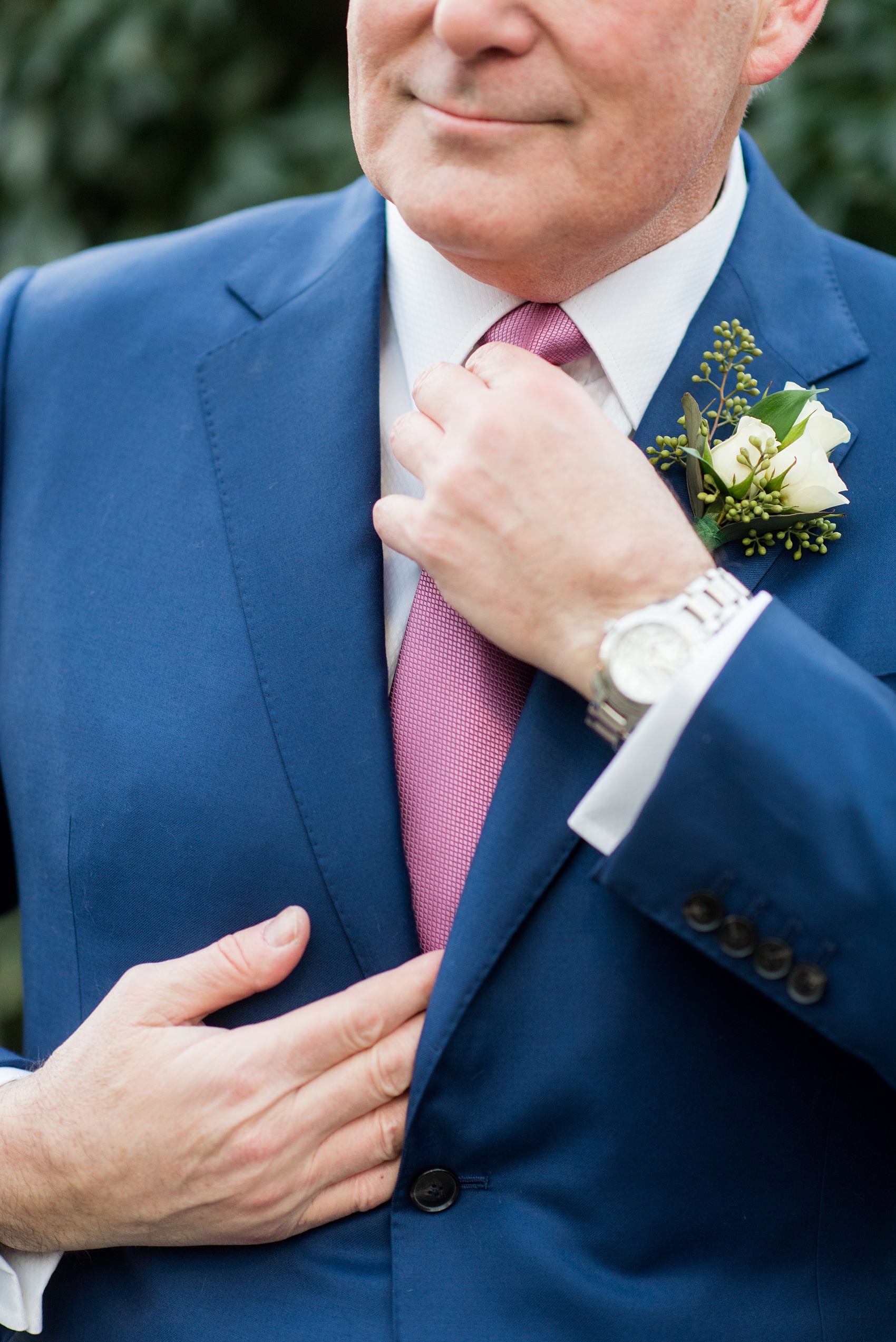 Photos by Mikkel Paige Photography of a Central Park Wedding ceremony and reception at the Loeb Boathouse venue with a romantic theme. Picture of the groom straightening his silk Japanese tie to prepare for his winter wedding day. Click through for more images! #CentralParkWedding