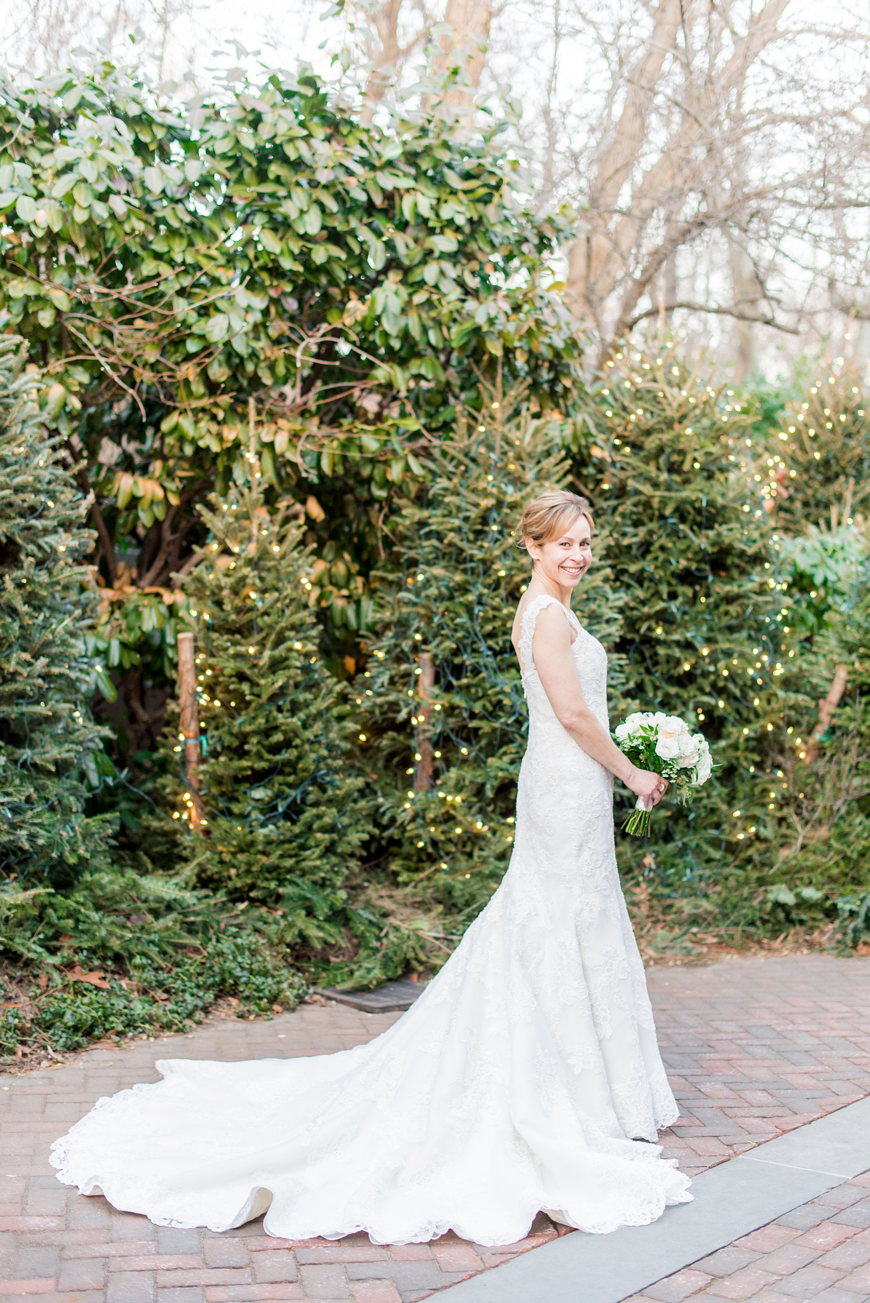 Photos by Mikkel Paige Photography of a Central Park Wedding ceremony and reception at the Loeb Boathouse venue with a romantic theme. A picture of the bride in her lace gown during her winter wedding. Click through for more images from their day! #CentralParkWedding