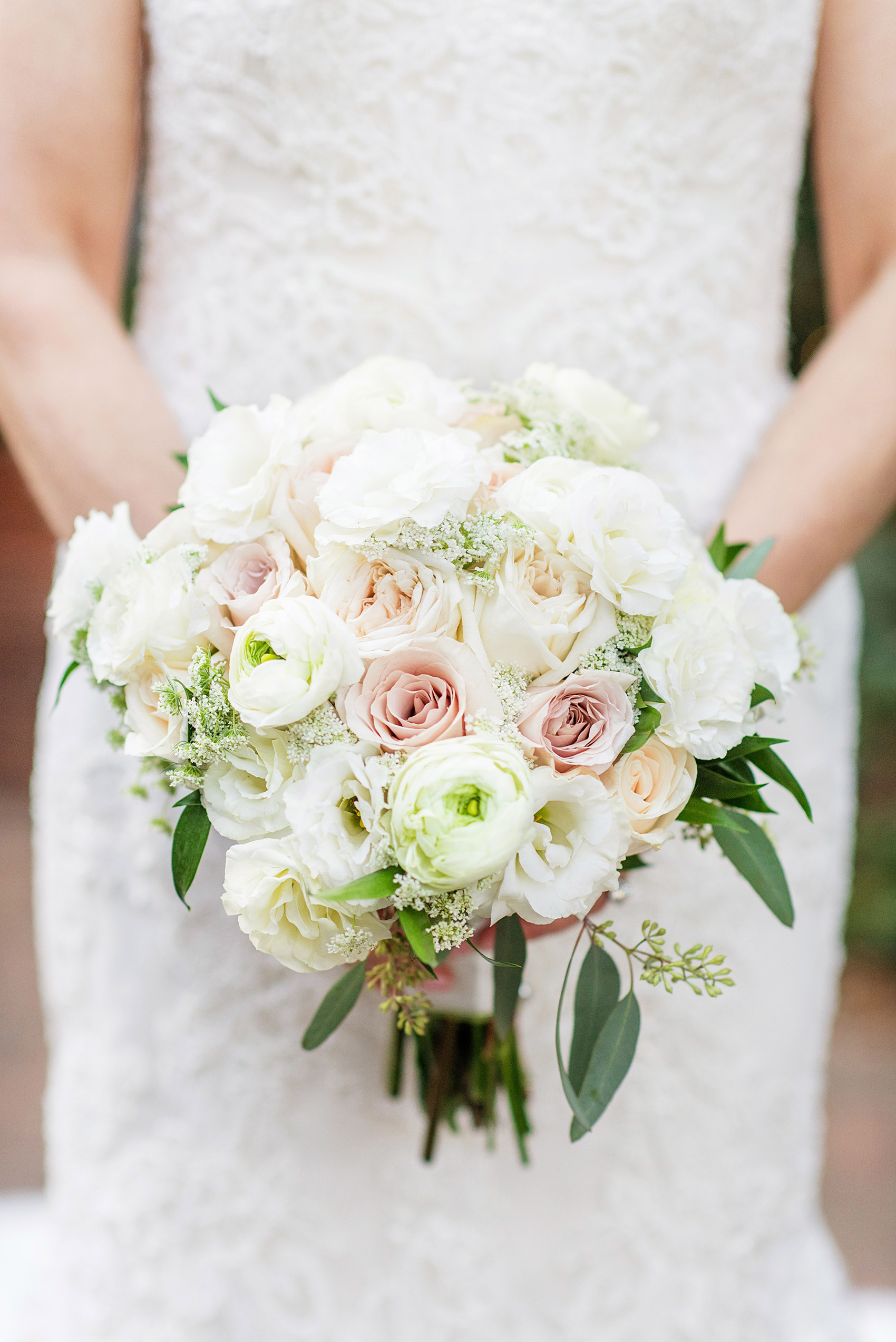 Photos by Mikkel Paige Photography of a Central Park Wedding ceremony and reception at the Loeb Boathouse venue with a romantic theme. Detail picture of the bride's ranunculus, rose and Queen Anne's Lace bouquet for her winter wedding. Click through for more images from her day! #CentralParkWedding