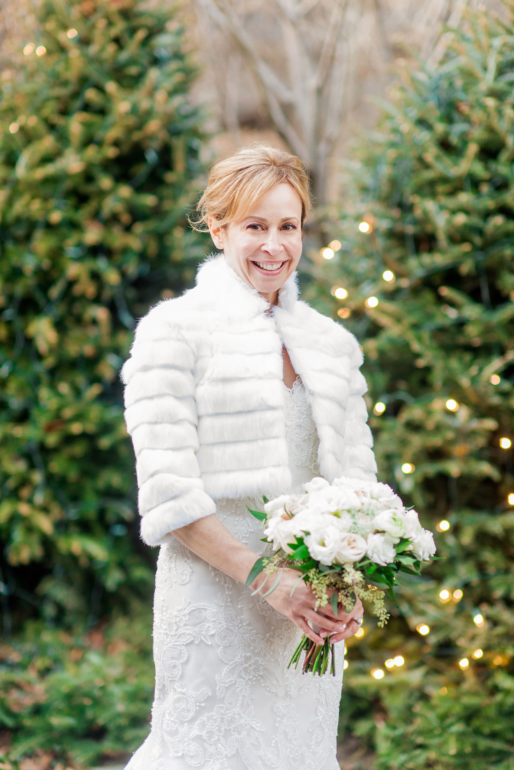 Photos by Mikkel Paige Photography of a Central Park Wedding ceremony and reception at the Loeb Boathouse venue with a romantic theme. A picture of the bride in her white fur jacket during her winter wedding. Click through for more images from their day! #CentralParkWedding