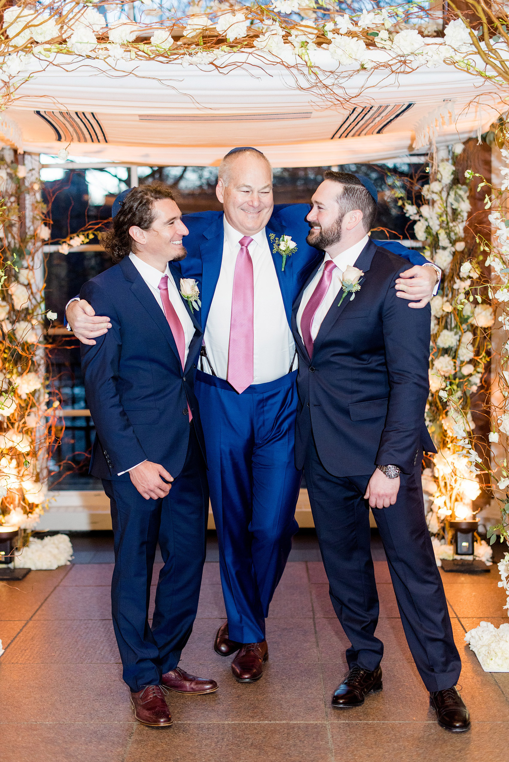 Photos by Mikkel Paige Photography of a Central Park Wedding reception at the Loeb Boathouse venue with a romantic theme. Picture of the groom with his sons under the winter inspired chuppah for their Jewish ceremony. Click through for more images from their day! #CentralParkWedding