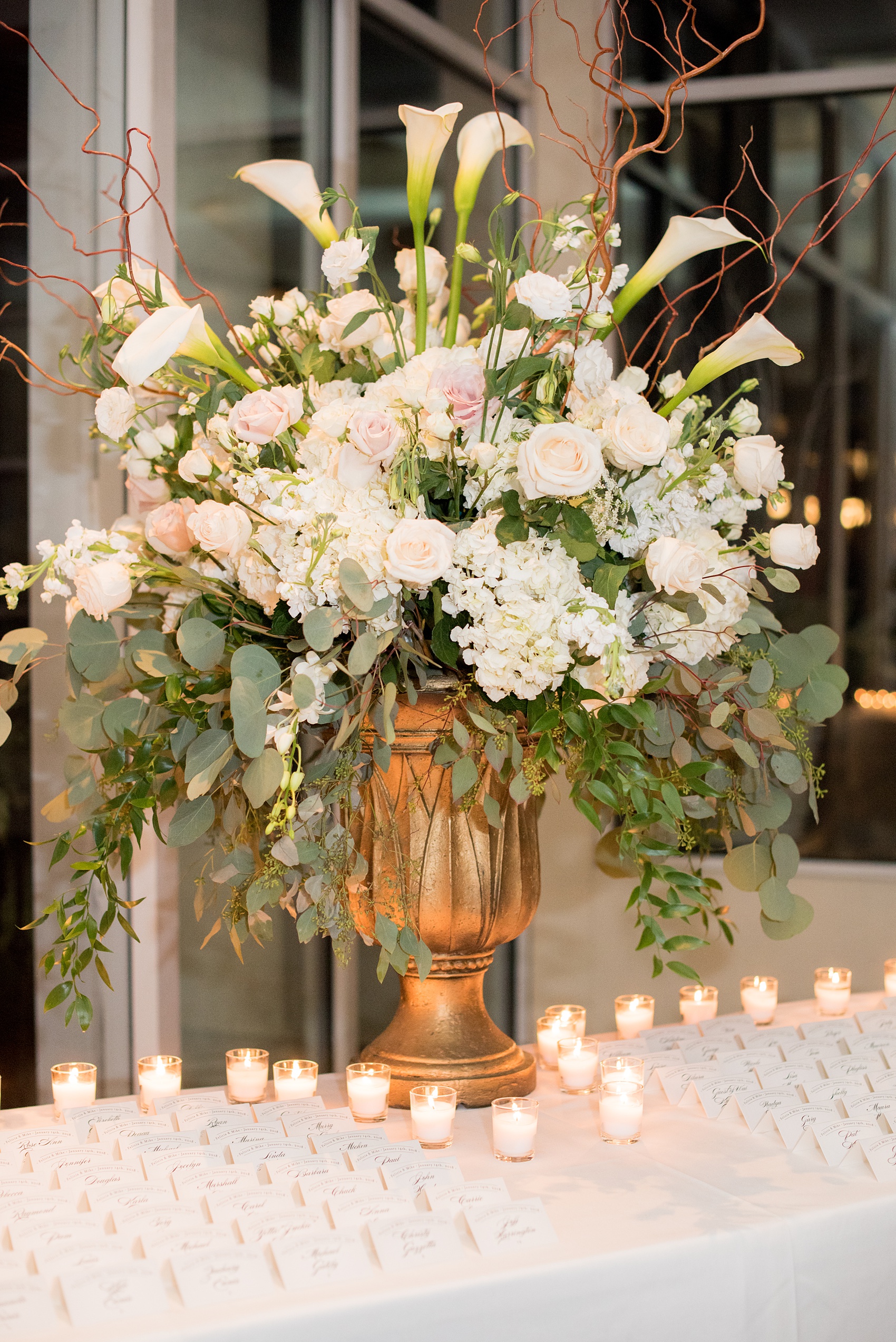 Photos by Mikkel Paige Photography of a Central Park Wedding ceremony and reception at the Loeb Boathouse venue with a romantic theme. Picture of the white and green flowers with candlelight and hand calligraphed escort cards. Click through for more images from their day! #CentralParkWedding