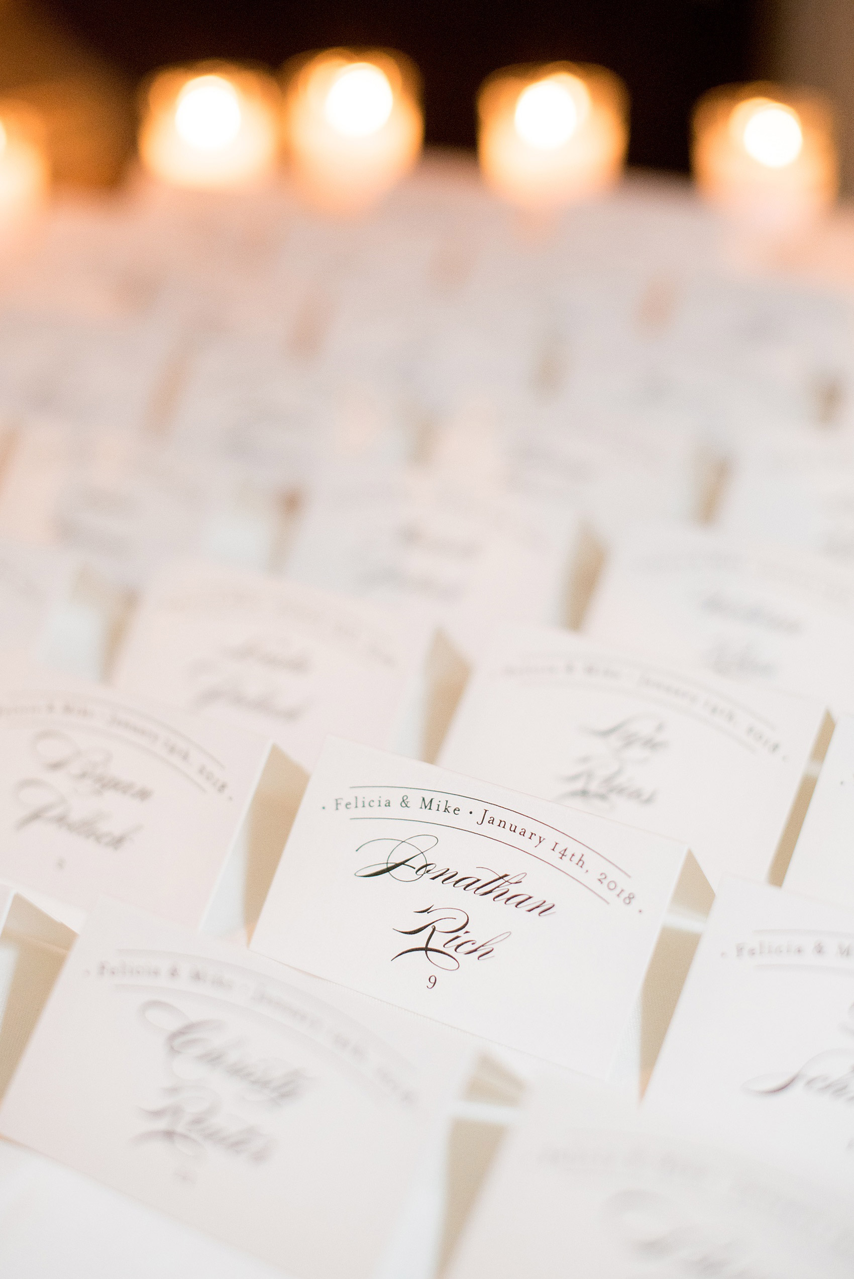 Photos by Mikkel Paige Photography of a Central Park Wedding ceremony and reception at the Loeb Boathouse venue with a romantic theme. Picture of the white and green flowers with candlelight and hand calligraphed escort cards. Click through for more images from their day! #CentralParkWedding