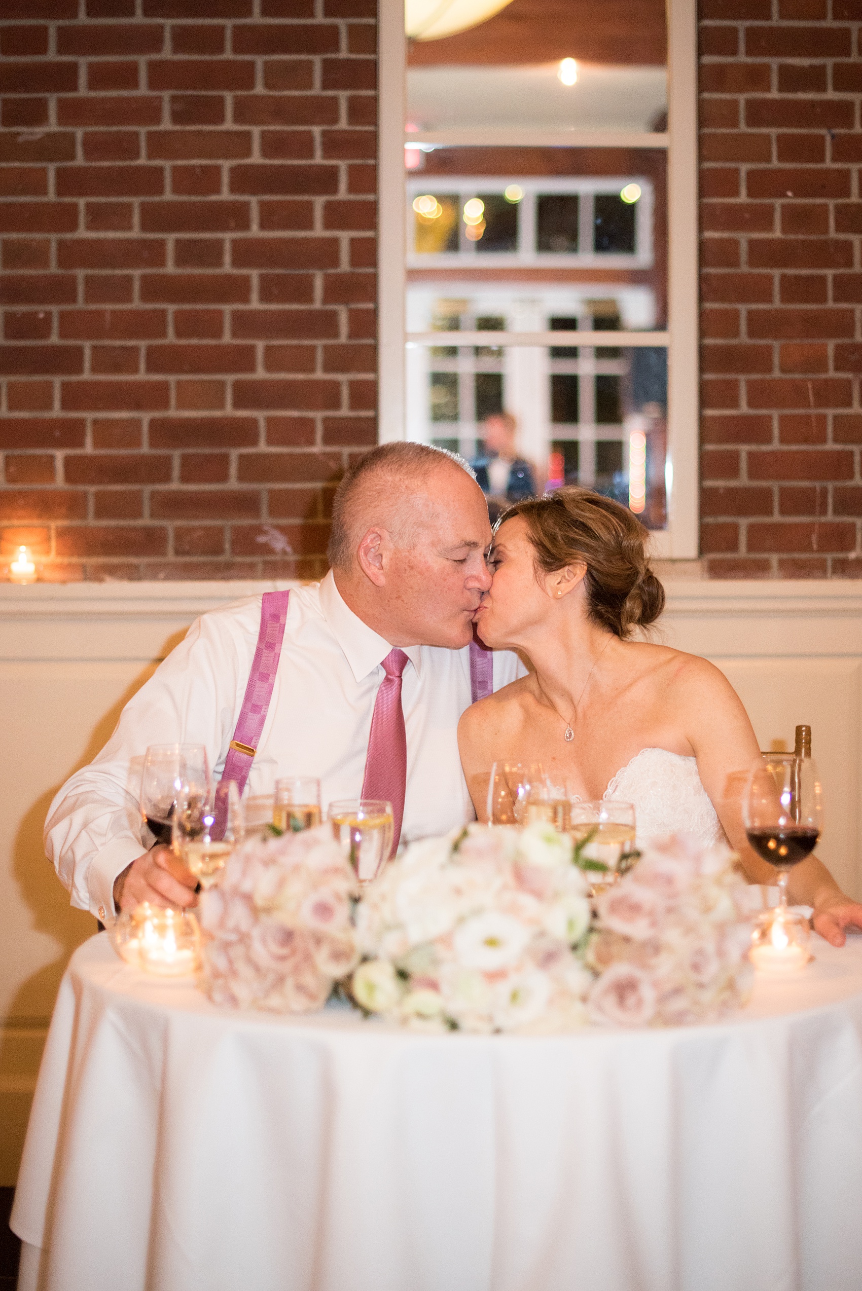 Photos by Mikkel Paige Photography of a Central Park Wedding reception at the Loeb Boathouse venue with a romantic winter theme. Picture of the bride and groom at their sweetheart table. Click through for more images from this beautiful day! #CentralParkWedding