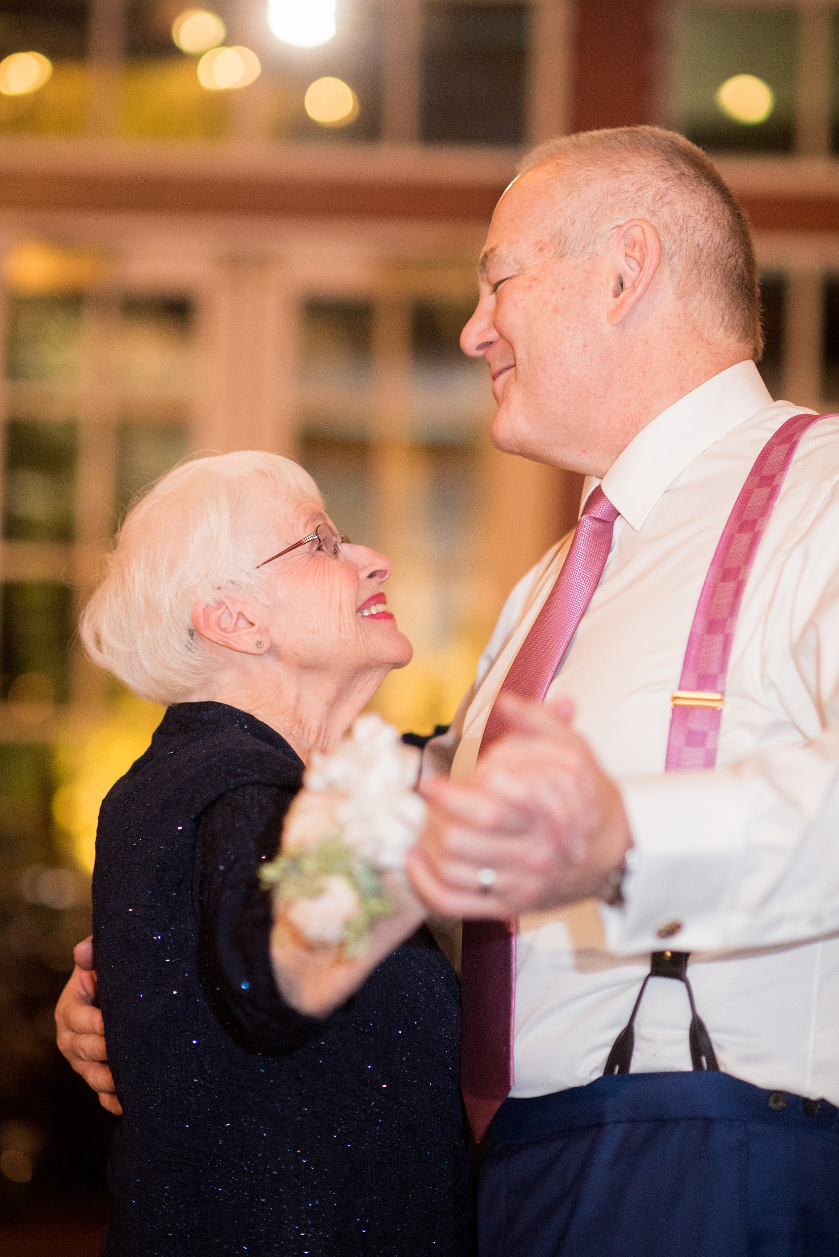 Photos by Mikkel Paige Photography of a Central Park Wedding reception at the Loeb Boathouse venue with a romantic winter theme. Picture of the groom dancing with the mother of the bride. Click through for more images from this beautiful day! #CentralParkWedding