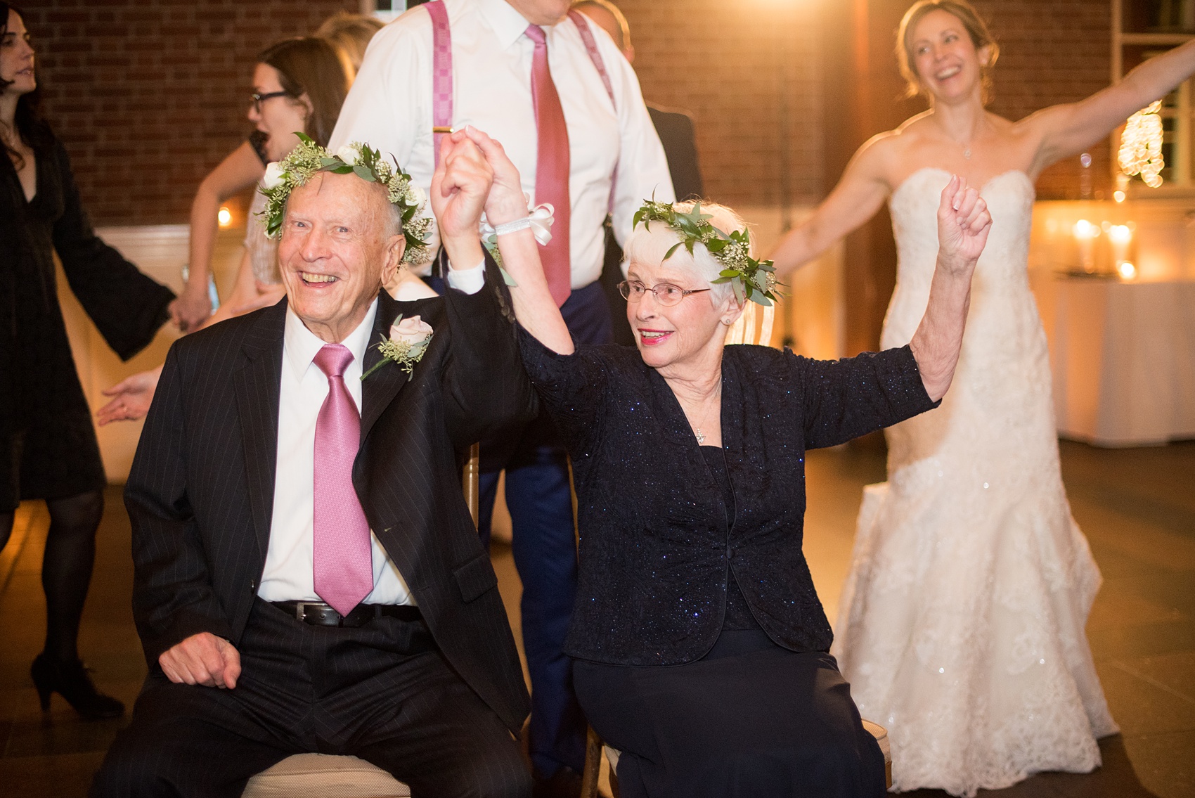 Photos by Mikkel Paige Photography of a Central Park Wedding reception at the Loeb Boathouse venue with a romantic winter theme. Picture of the Jewish tradition mizinke flower crowns and dance. Click through for more images from this beautiful day! #CentralParkWedding