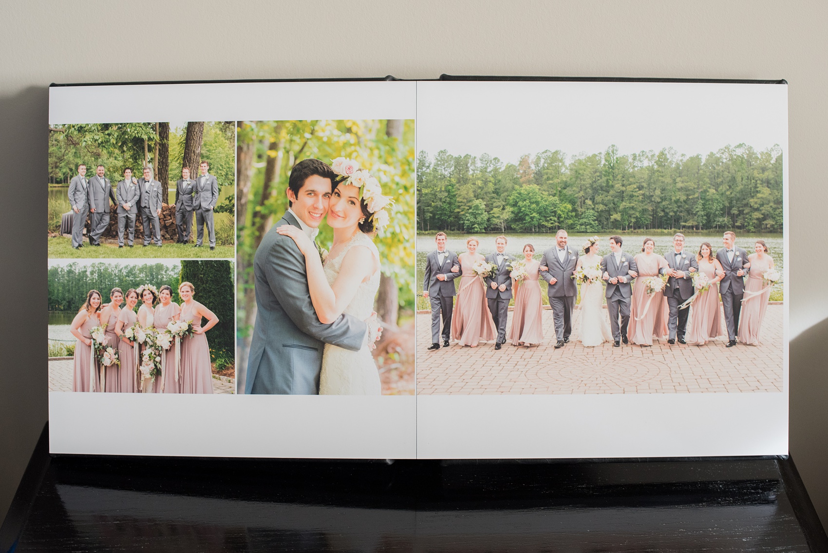 Images of a black calf leather fine art wedding album from Mikkel Paige Photography, a Raleigh, NC photographer. Photo shows a beautiful layout of the bride, groom and wedding party at The Pavilion at Angus Barn.