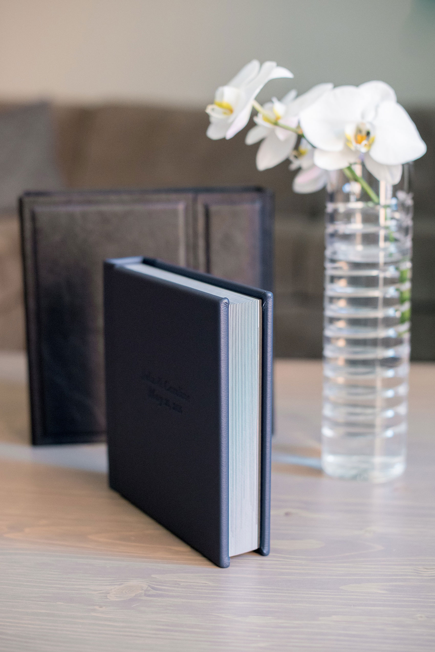 Images of a fine art leather wedding album in navy blue from Mikkel Paige Photography, a Raleigh, NC photographer.