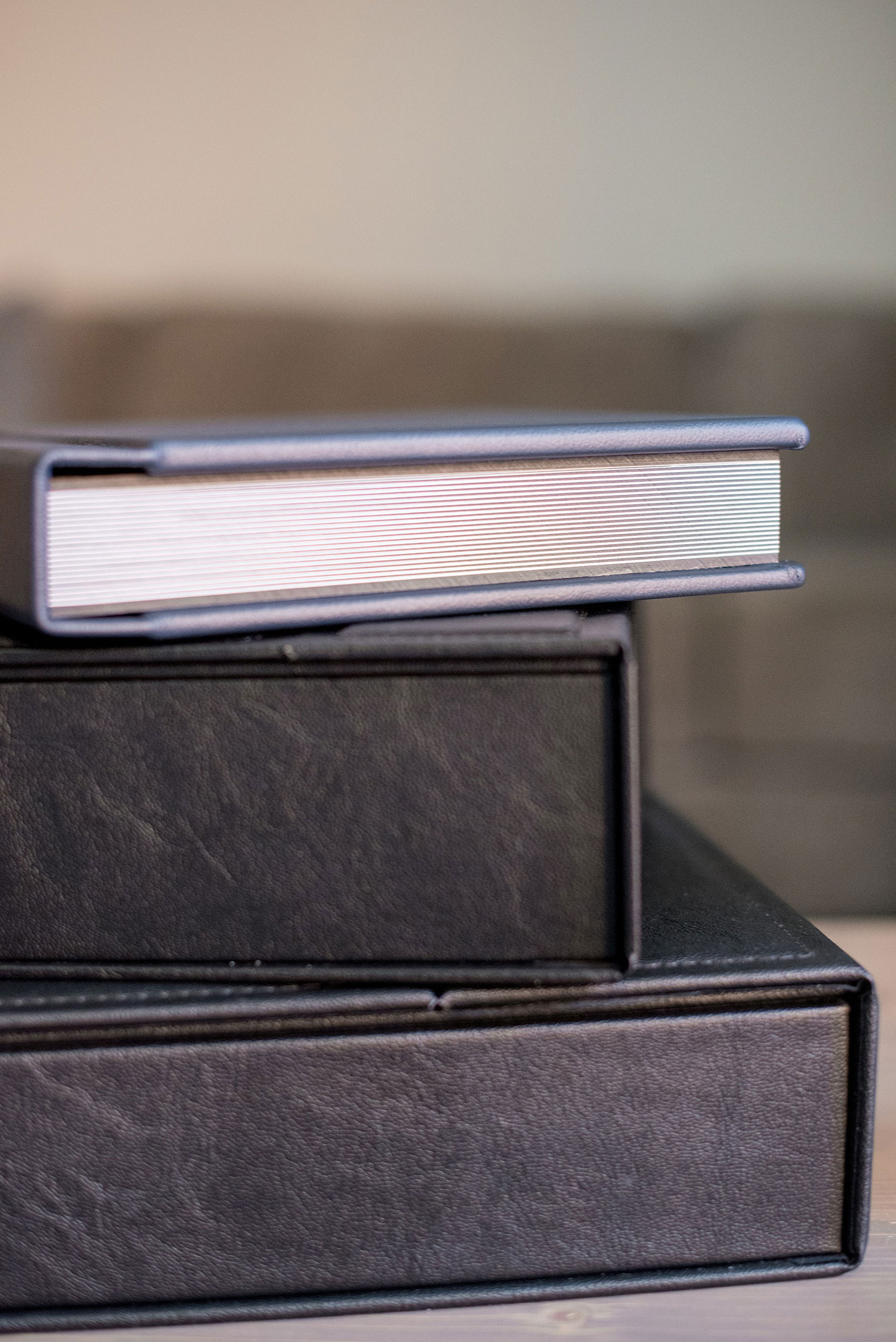 Images of a fine art leather wedding album in navy blue from Mikkel Paige Photography, a Raleigh, NC photographer.