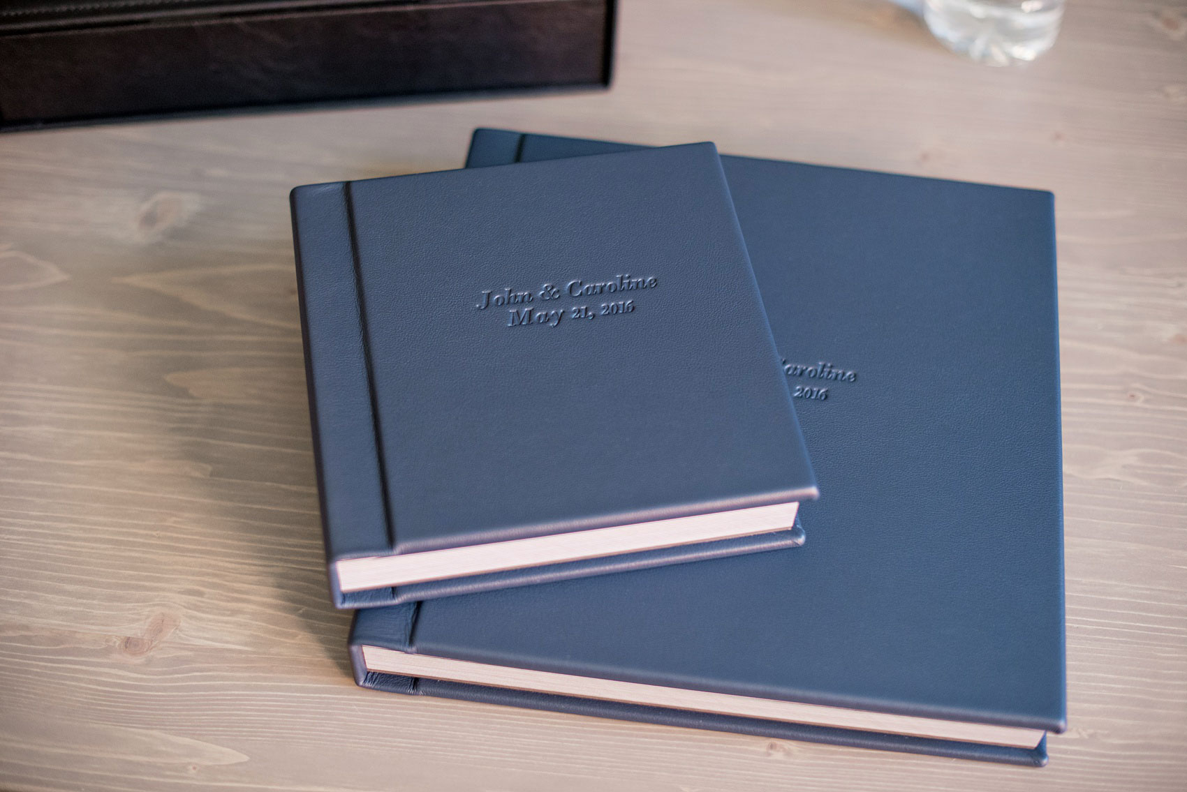 Images of a fine art leather wedding album in navy blue from Mikkel Paige Photography, a Raleigh, NC photographer.