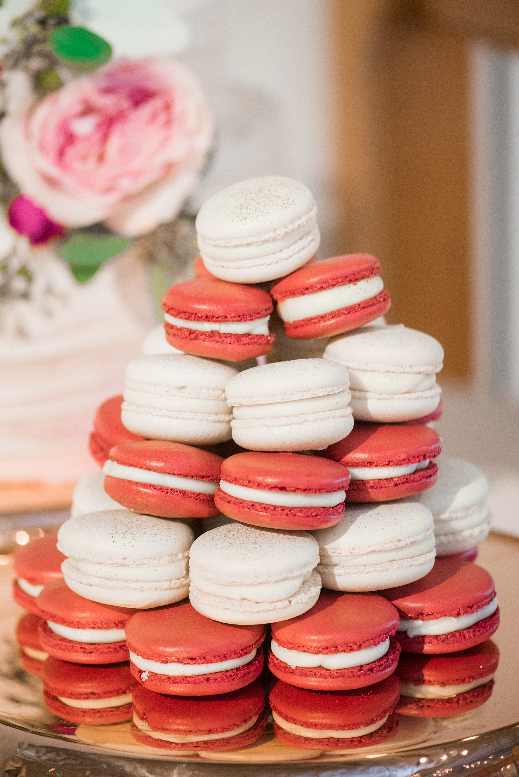 Photos from a wedding in downtown Raleigh, NC by Mikkel Paige Photography. The reception dessert options included cake and red and white macarons, topped with edible glitter, by The Cupcake Shoppe.