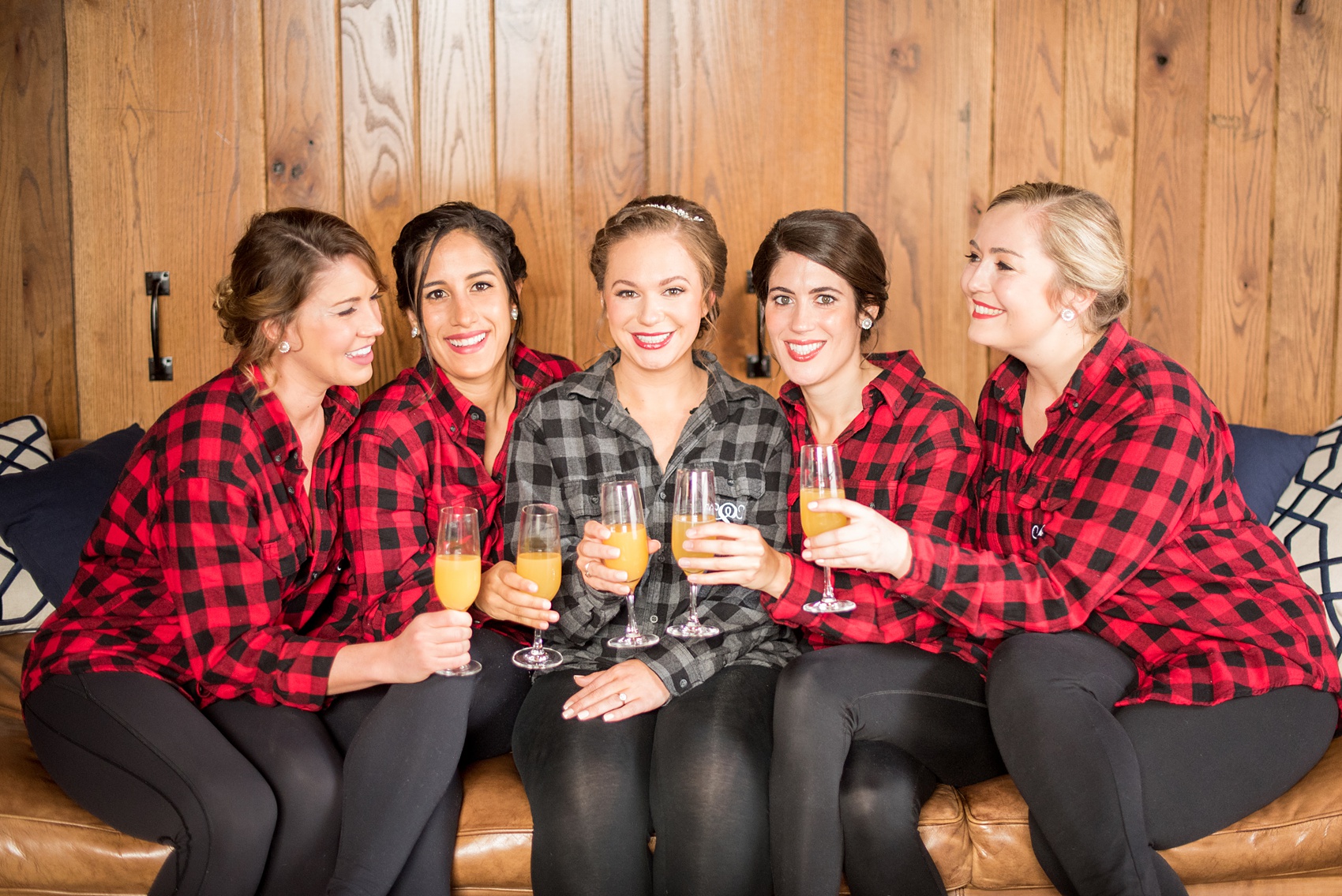 Durham wedding photos at The Cookery by Mikkel Paige Photography in North Carolina. The brought gifted her bridesmaids monogrammed button-down plaid shirts with their first initial on the pocket, as shown in this picture, for the getting ready and mimosa portion of the winter morning.