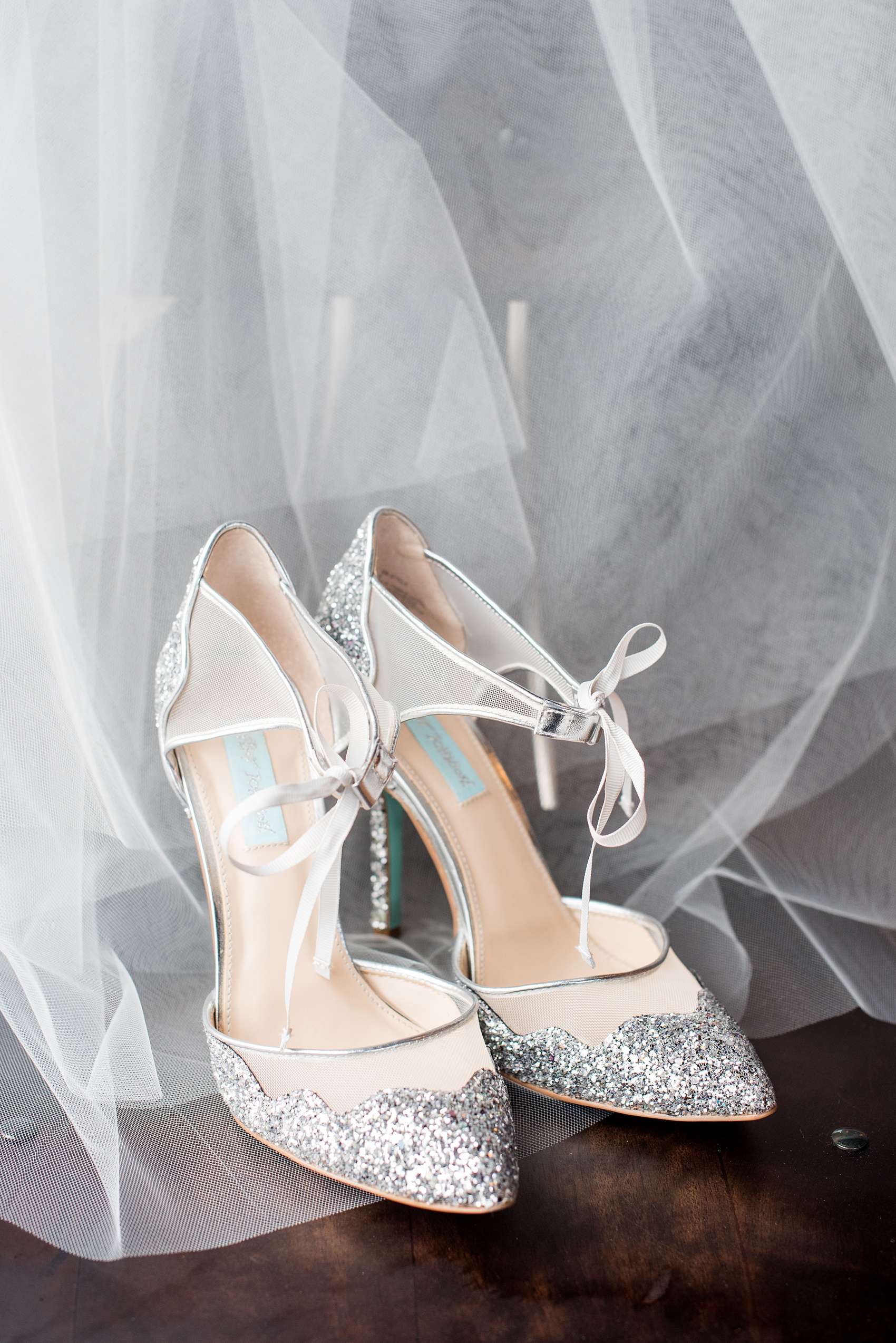 Durham wedding photos at The Cookery by Mikkel Paige Photography in North Carolina. The bride wore silver glitter and white mesh heels by Betsy Johnson and wore a simple veil.
