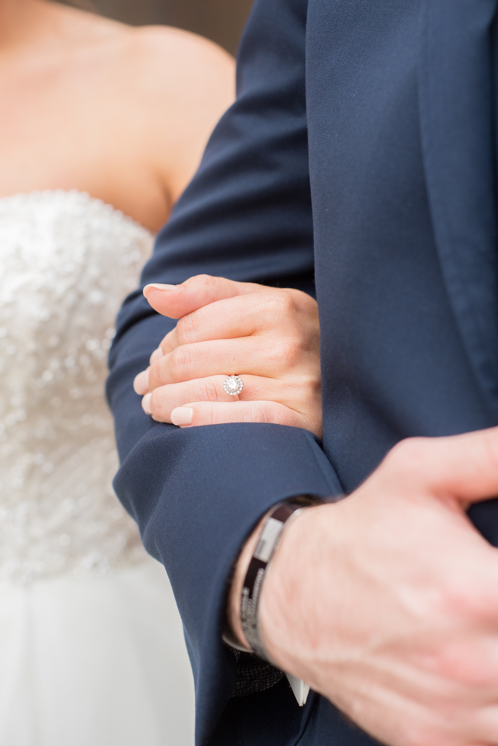 Durham wedding photos at The Cookery by Mikkel Paige Photography in North Carolina. The bride wore a strapless beaded gown and held the arm of her groom in this wedding picture.