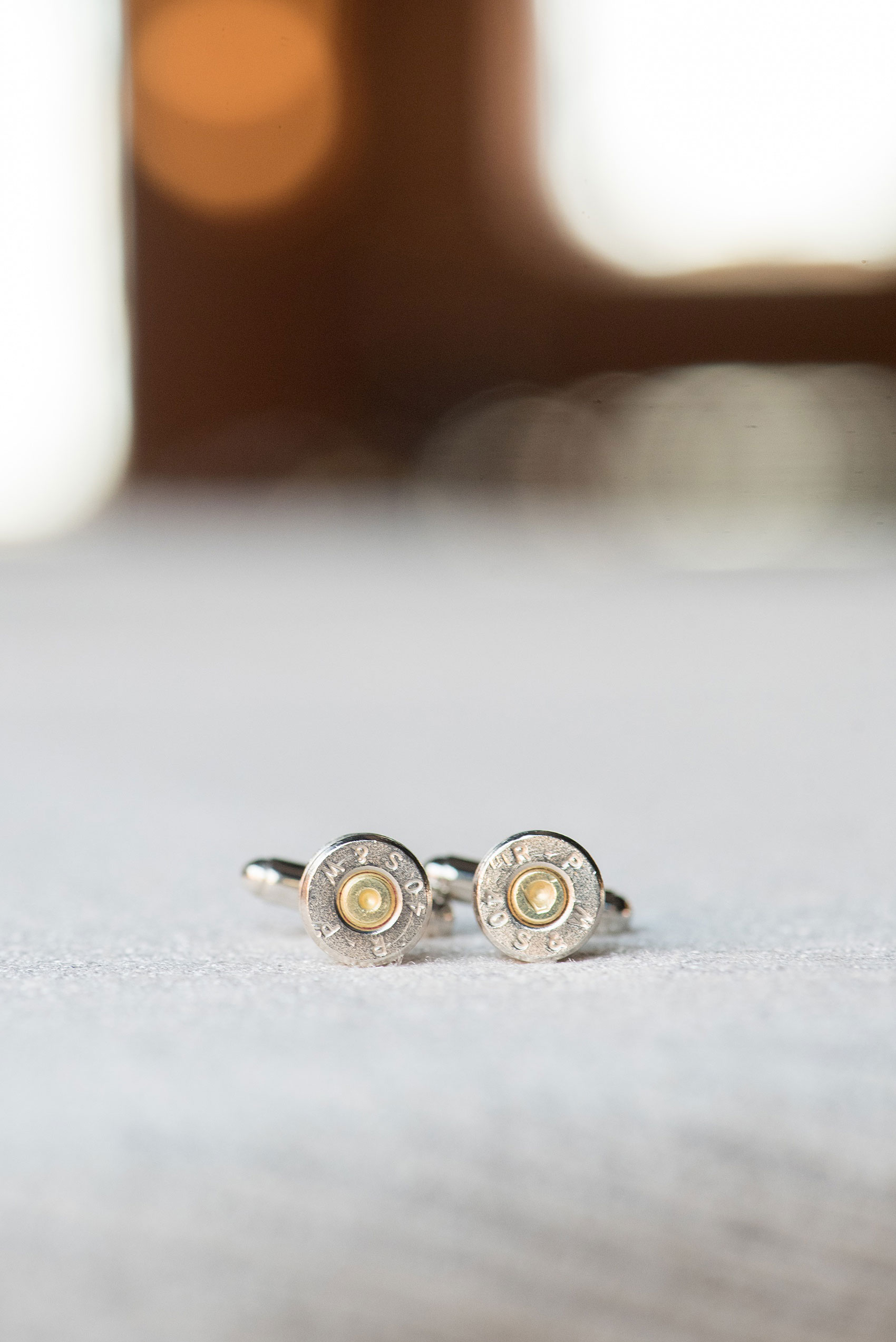 Durham wedding photos at The Cookery by Mikkel Paige Photography in North Carolina. The groomsmen wore a detail of bullet cufflinks, all police officers and some ex-military friends of the groom.