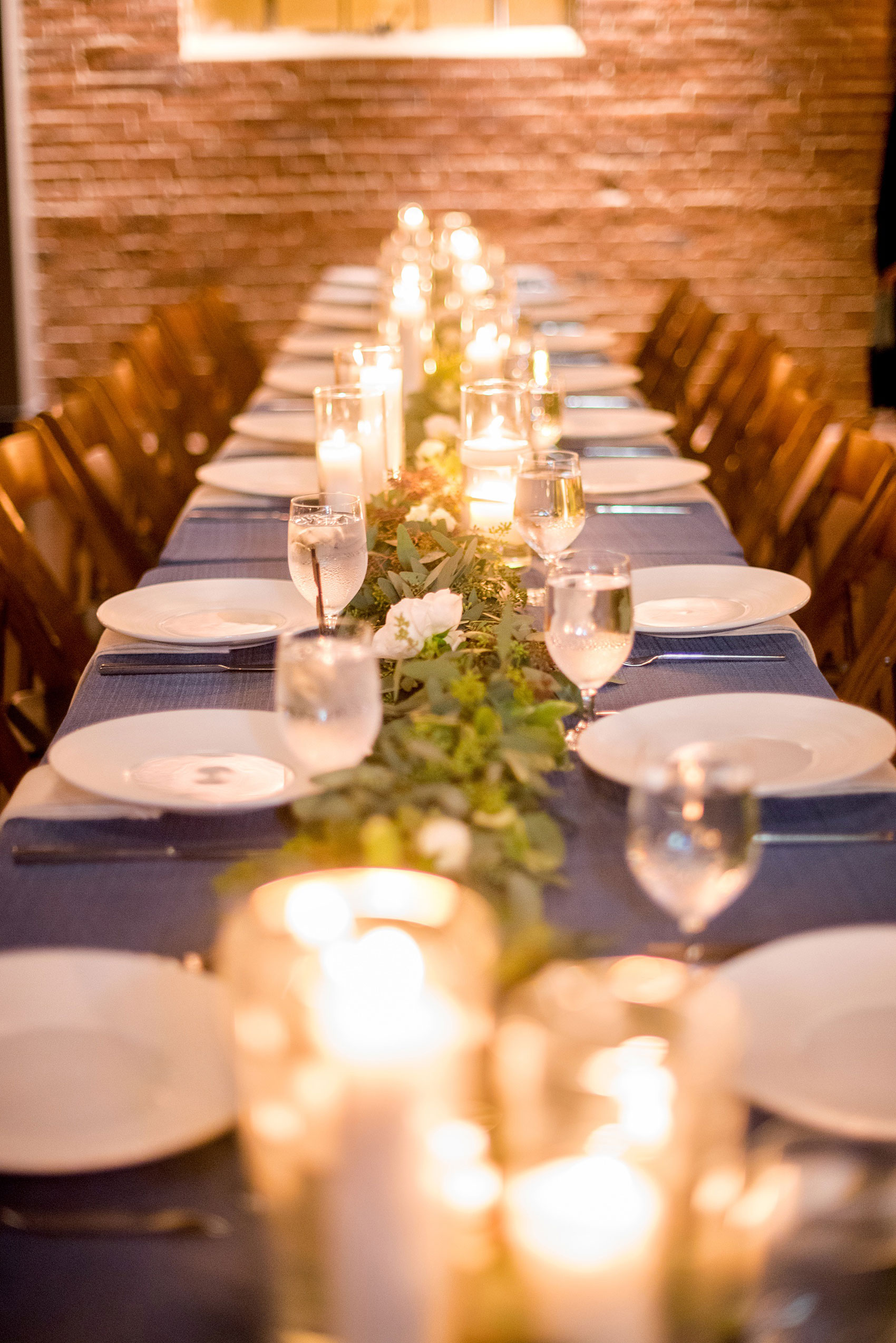 Durham wedding photos at The Cookery by Mikkel Paige Photography in North Carolina. The reception room had white and blue linens and lots of candlelight.
