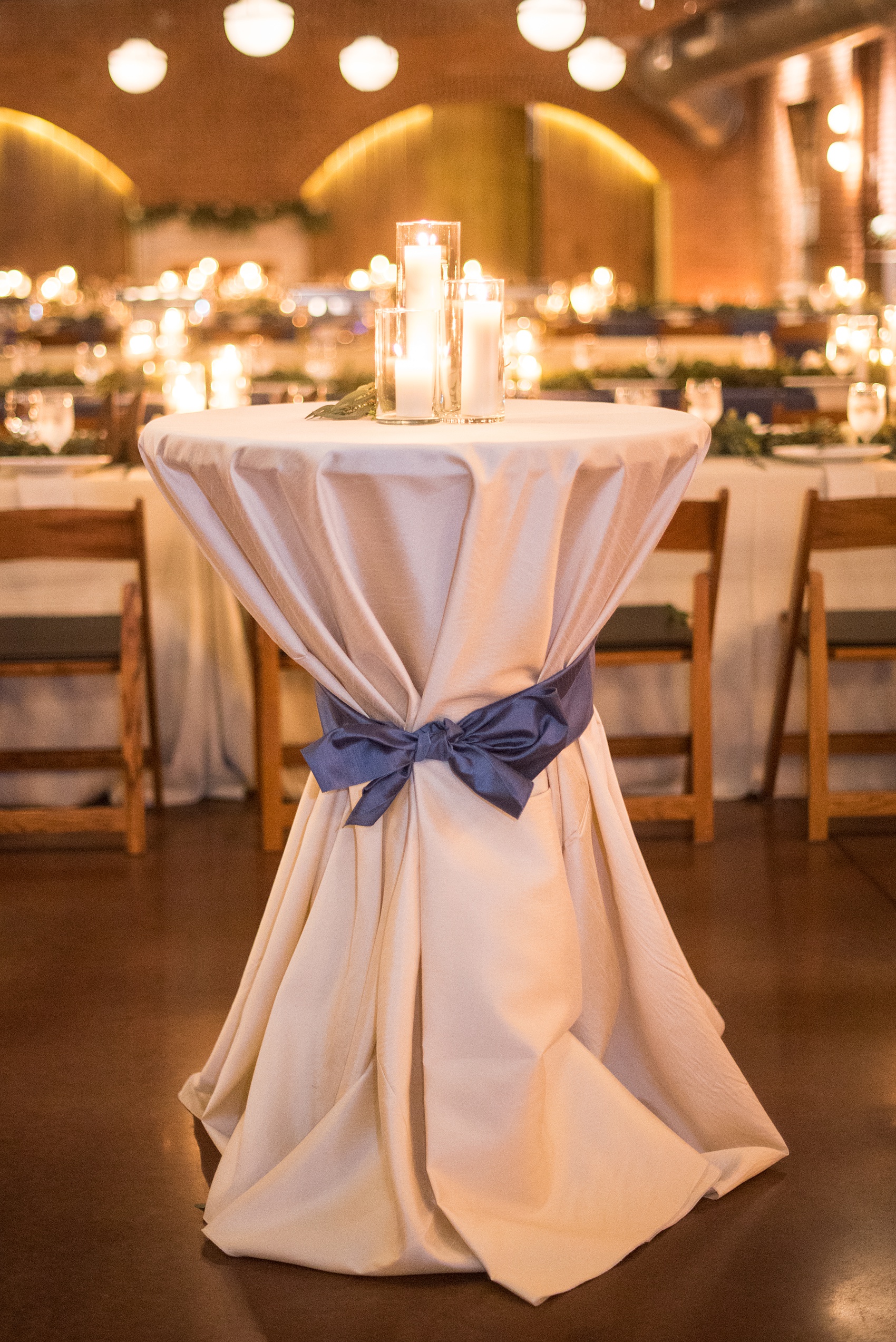 Durham wedding photos at The Cookery by Mikkel Paige Photography in North Carolina. The reception room had white and blue linens and lots of candlelight.