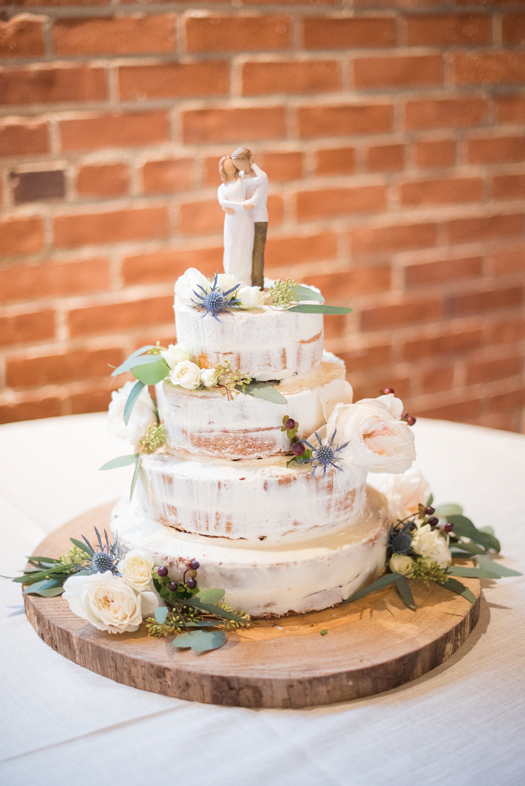 Durham wedding photos at The Cookery by Mikkel Paige Photography in North Carolina. The small buttercream cake was a special naked-cake design by her sister and Maid of Honor. It was decorated with eucalyptus and rose flowers.