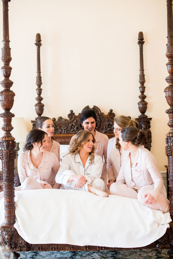 Wedding photos at Sleepy Hollow Country Club for a winter reception in January by Mikkel Paige Photography. Picture of the bride with her bridesmaids in pajamas before they got dressed for the day.