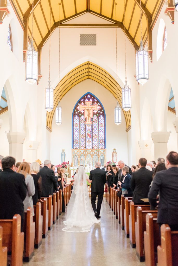 Wedding photos at Sleepy Hollow Country Club for a winter reception in January by Mikkel Paige Photography. A picture of the bride's father walking her down the aisle during their small church ceremony in New York.