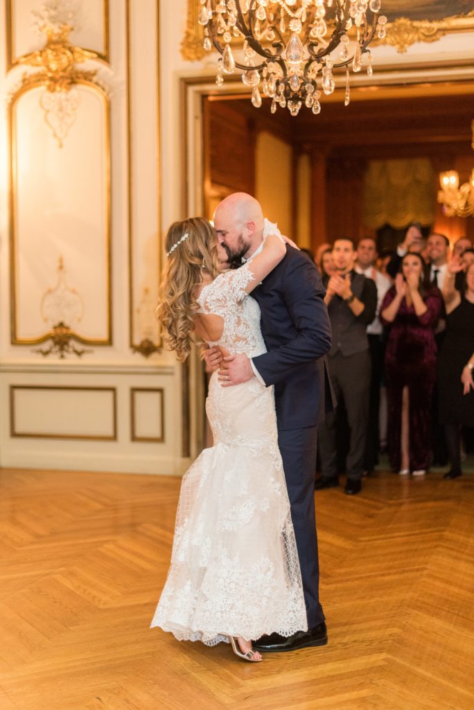 Wedding photos at Sleepy Hollow Country Club for a winter reception in January by Mikkel Paige Photography. They shared their first dance at their NY winter wedding, inside the ornate center room of the venue.