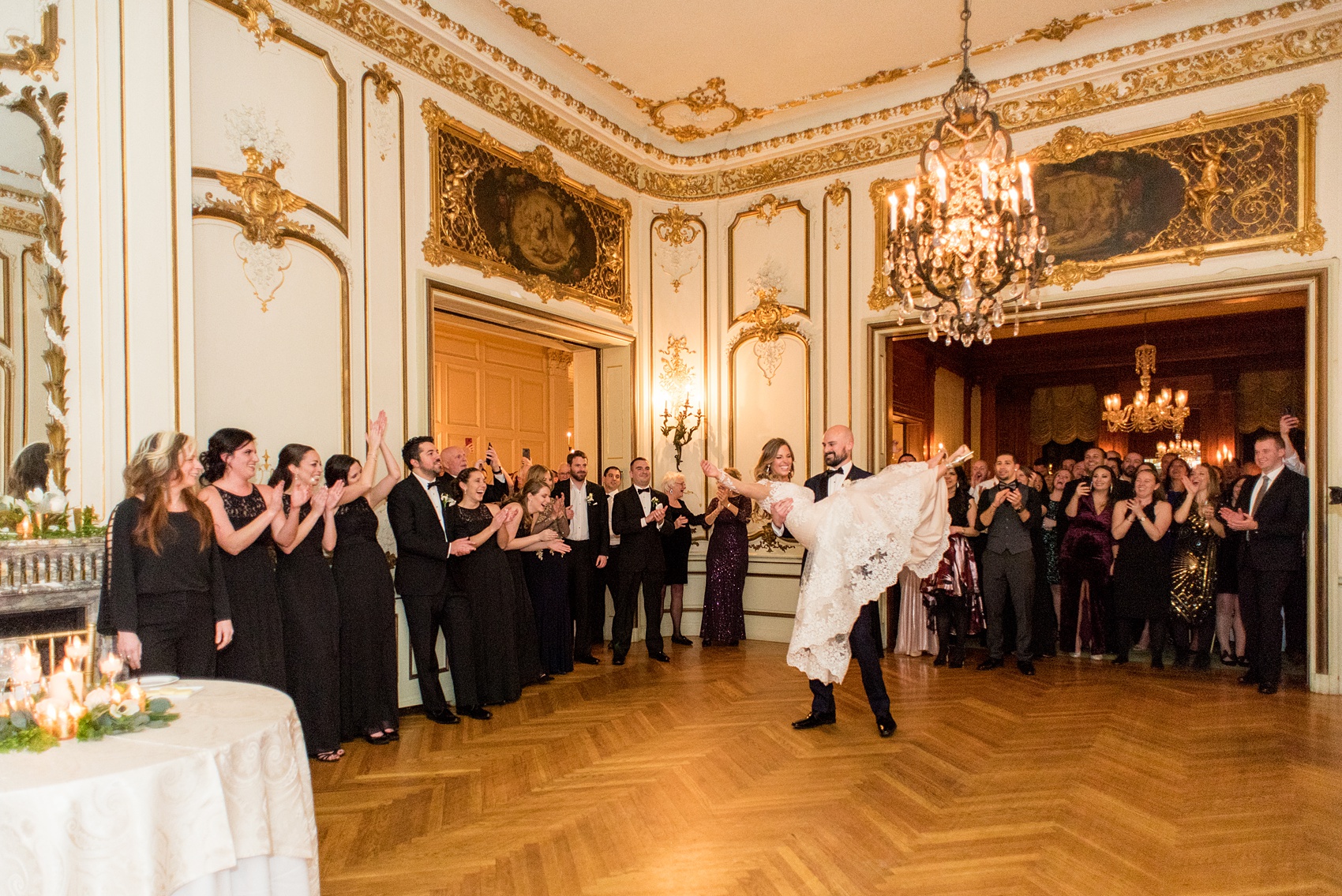 Wedding photos at Sleepy Hollow Country Club for a winter reception in January by Mikkel Paige Photography. They shared their first dance at their NY winter wedding, inside the ornate center room of the venue and ended with the groom lifting the bride for a twirl! 