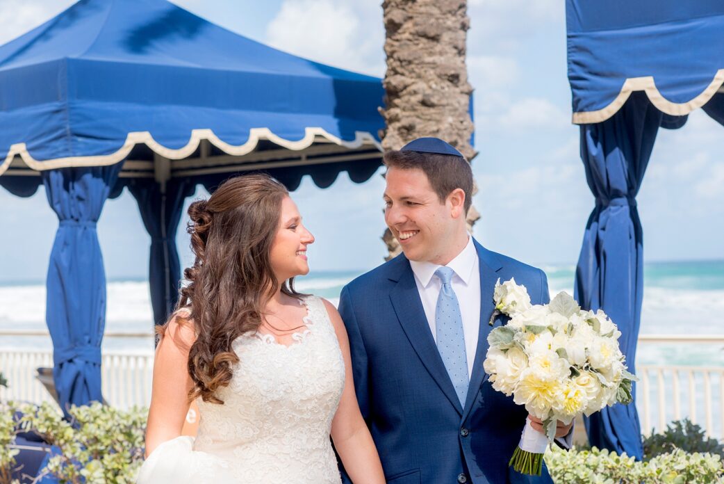 Wedding photos at Eau Palm Beach by Mikkel Paige Photography. Pictures right next to the ocean for a destination wedding. The bride and groom shared a spring wedding day.