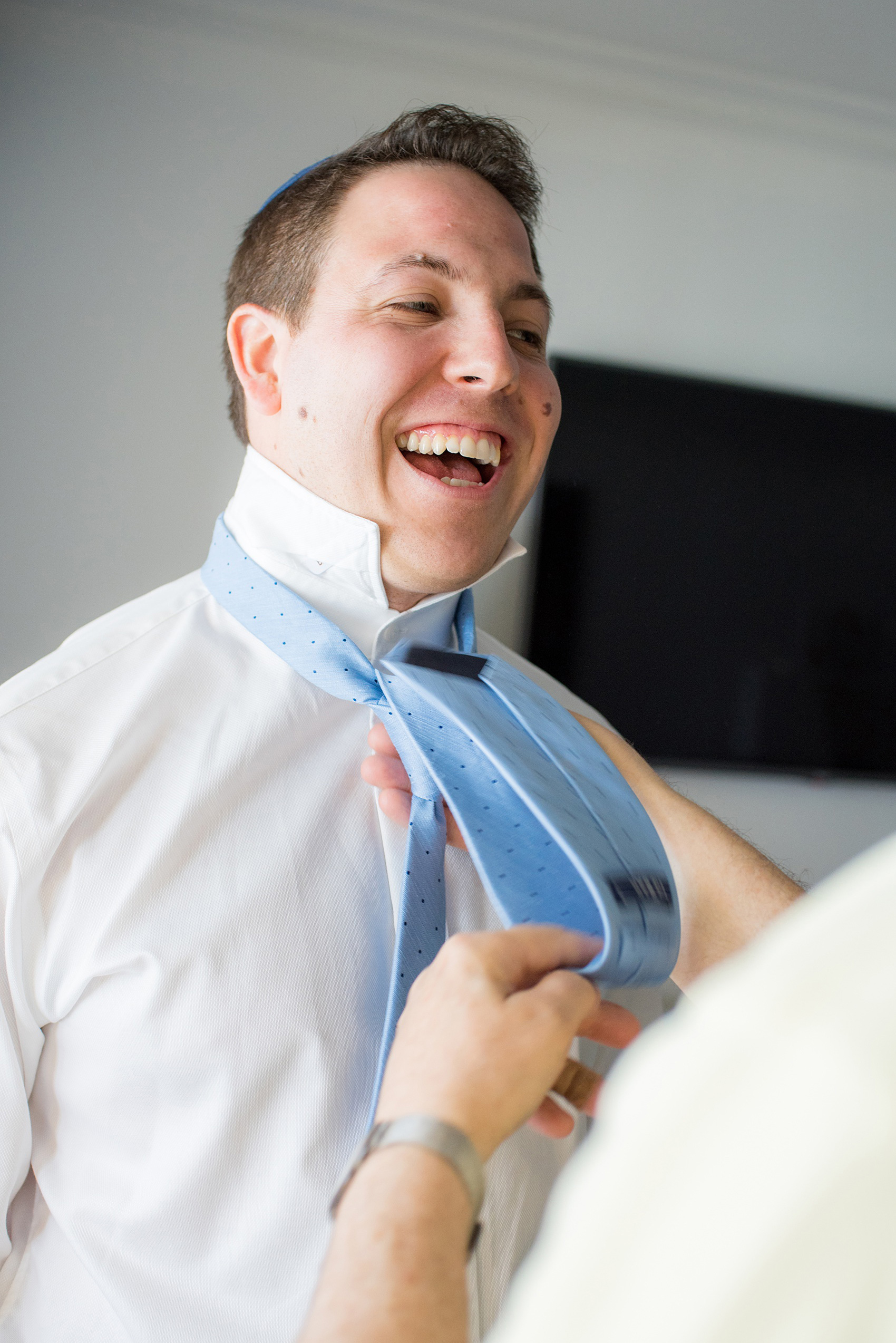 Eau Palm Beach wedding photos by Mikkel Paige Photography. The groom prepared for his day with his father helping tie his light blue tie. This luxury, beach front Florida resort is a great destination location for a wedding! Click through for more! #WestPalmBeach