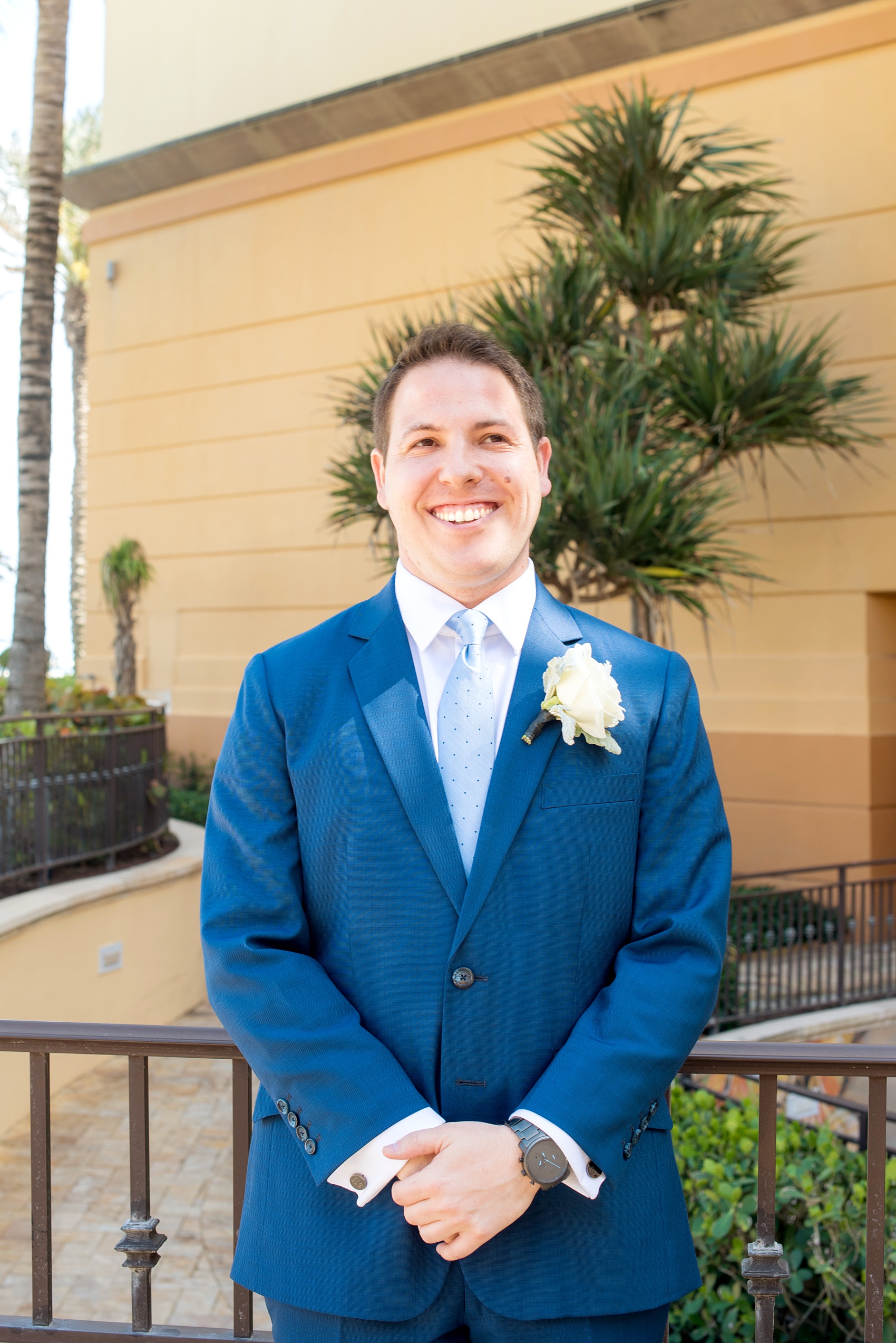 Eau Palm Beach wedding photos by Mikkel Paige Photography. This luxury Florida hotel is a beautiful location for a destination wedding. The groom wore a navy suit with a white rose boutonniere and light blue dot tie. Click through to see more! #WestPalmBeach #EauPalmBeach #BeachWedding #FloridaWeddings