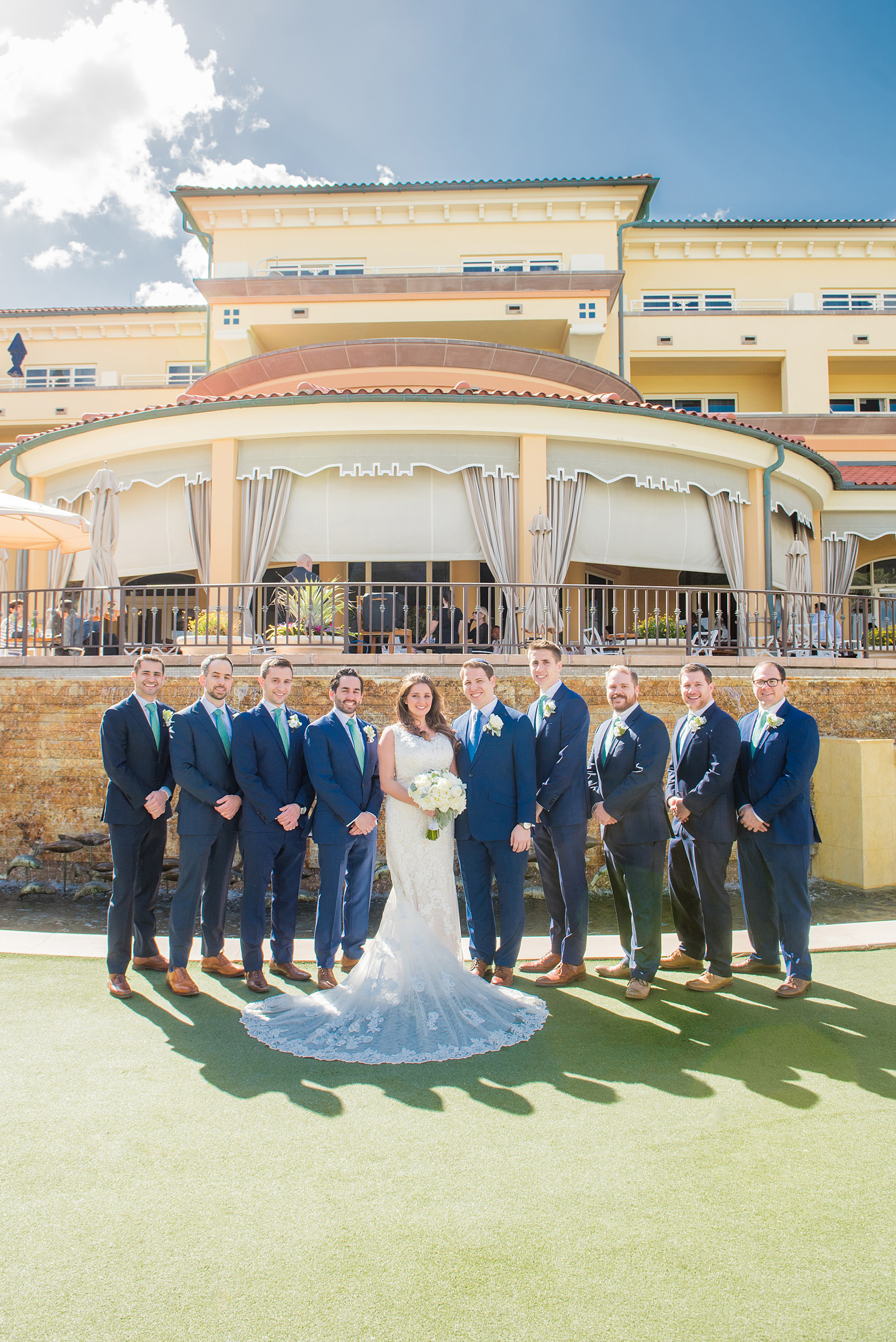 Eau Palm Beach wedding photos by Mikkel Paige Photography. This luxury Florida hotel is a beautiful location for a destination wedding. The groomsmen wore navy blue suits with a white snapdragon boutonniere and aqua blue dot ties. Click through to see more beautiful photos from this ocean front wedding! #WestPalmBeach #EauPalmBeach #BeachWedding #FloridaWeddings #groomsmen