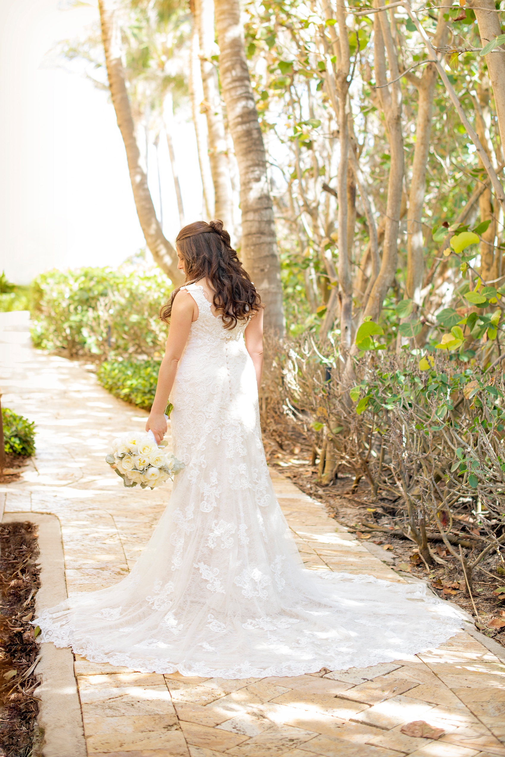 Eau Palm Beach wedding photos by destination photographer, Mikkel Paige. This luxury Florida hotel is a beautiful location for a destination wedding. The bride and wore a sleeveless lace gown and carried a white peony bouquet. Click through to see more! #WestPalmBeach #EauPalmBeach #BeachWedding #FloridaWeddings #BeachBride