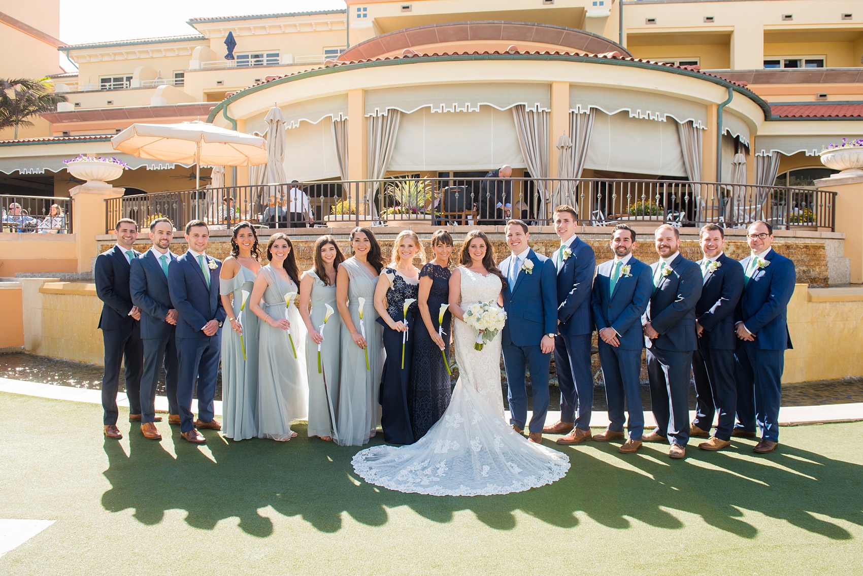 Eau Palm Beach wedding photos by destination photographer, Mikkel Paige. This luxury Florida hotel is a beautiful location for a destination wedding. The bridesmaids wore different types of seafoam/mint green chiffon gowns and groomsmen wore navy blue suits. Click through to see more! #WestPalmBeach #EauPalmBeach #BeachWedding #FloridaWeddings #BeachBride