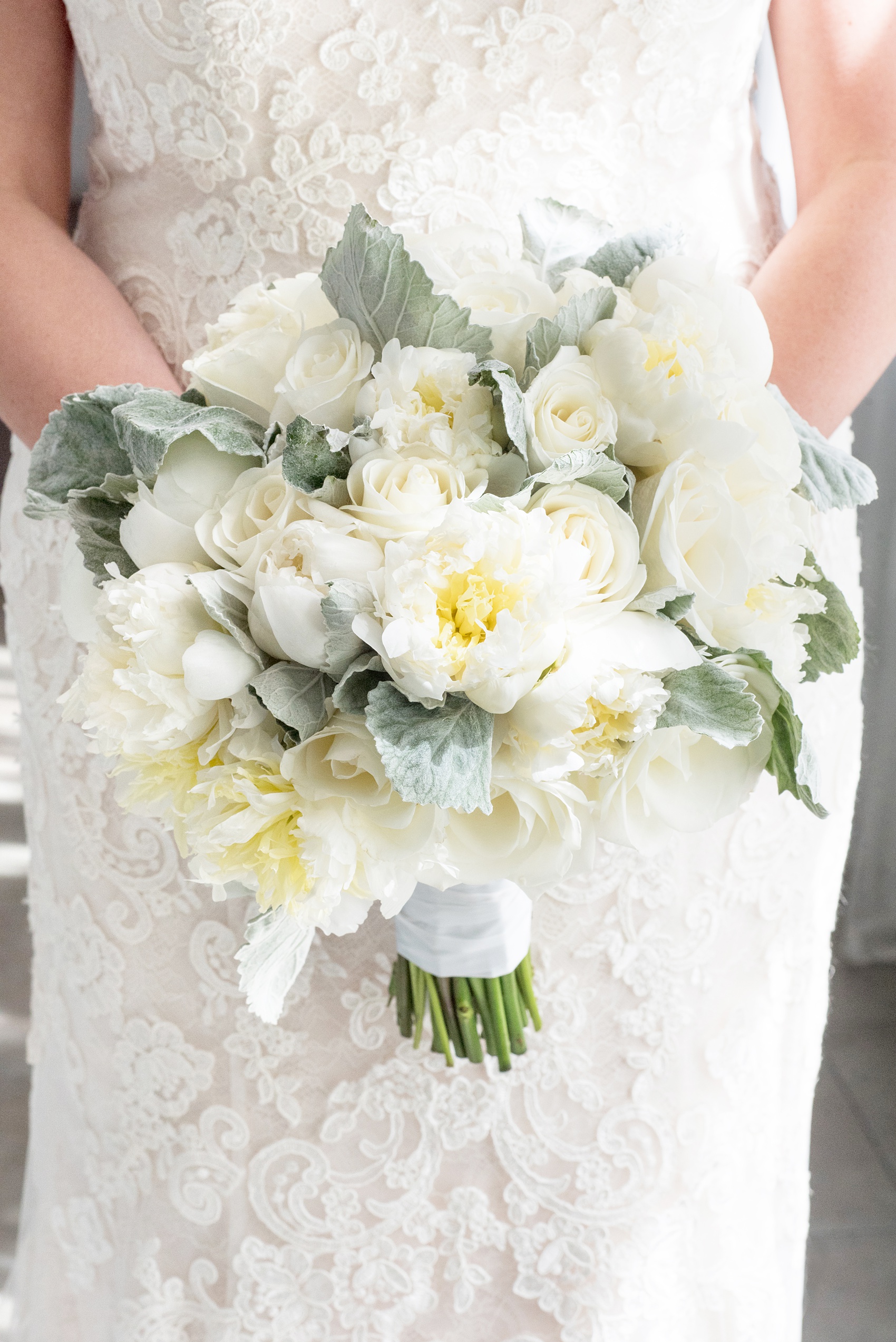 Eau Palm Beach wedding photos by Mikkel Paige Photography. This luxury Florida resort is a beautiful location for a destination wedding. This detail picture shows the brides white peony bouquet with Dusty Miller greenery. Click through for more! #WestPalmBeach #EauPalmBeach #BeachWedding #FloridaWeddings #BeachBride #Peonies #whitebouquet