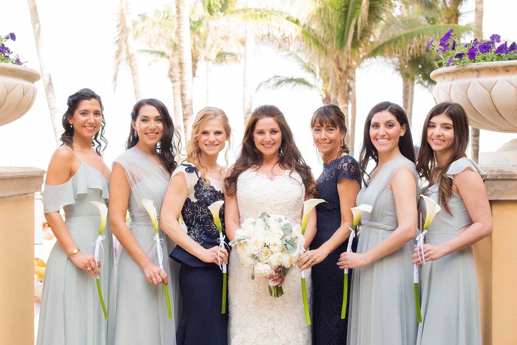 Eau Palm Beach wedding photos by destination photographer, Mikkel Paige. This luxury Florida hotel is a beautiful location for a destination wedding. The bridesmaids wore different types of seafoam/mint green chiffon gowns and the maids of honor wore navy blue. Click through to see more! #WestPalmBeach #EauPalmBeach #BeachWedding #FloridaWeddings #BeachBride