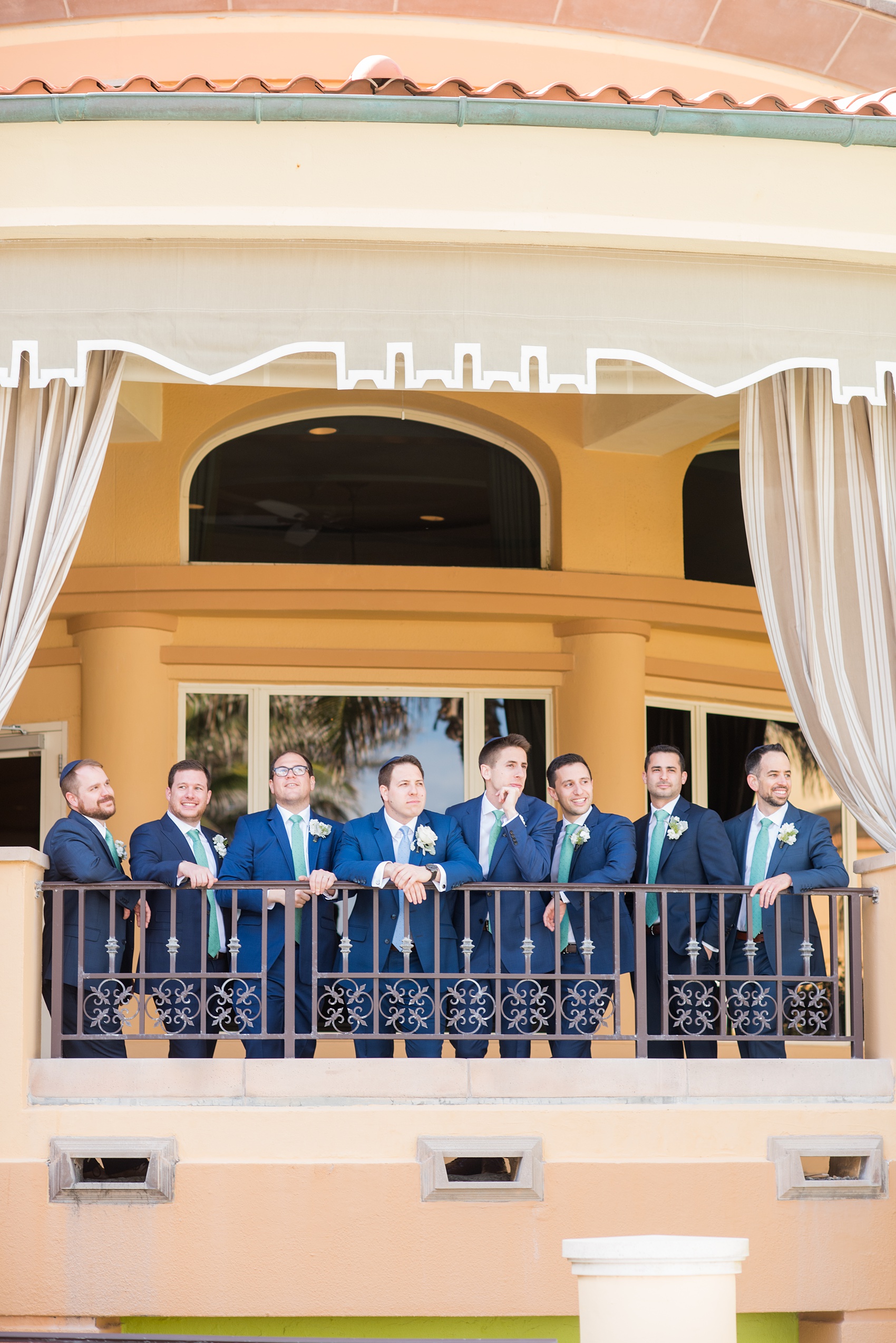Eau Palm Beach wedding photos by destination photographer, Mikkel Paige. This luxury Florida hotel is a beautiful location for a destination wedding. The bridesmaids wore different types of seafoam/mint green chiffon gowns and groomsmen wore navy blue suits. Click through to see more! #WestPalmBeach #EauPalmBeach #BeachWedding #FloridaWeddings #BeachBride