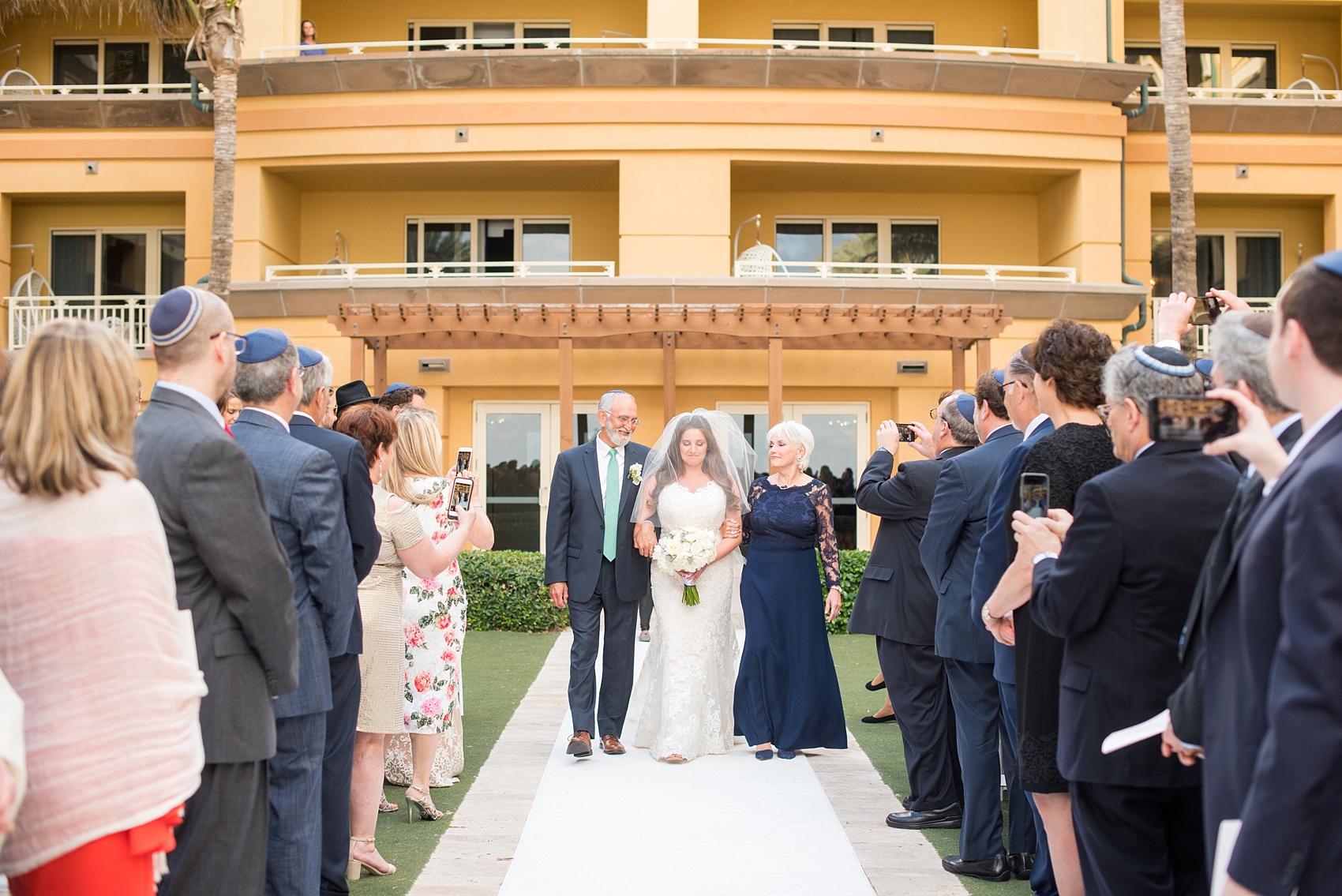 Eau Palm Beach wedding photos by destination photographer, Mikkel Paige. This luxury West Palm Beach, Florida hotel is a beautiful location for a destination wedding. The traditional Jewish ceremony had a bedekan and tish, followed by an outdoor ocean front ceremony under a gorgeous chuppah. Click through to see more! #WestPalmBeach #EauPalmBeach #BeachWedding #FloridaWeddings #BeachBride #Jewishwedding #chuppah