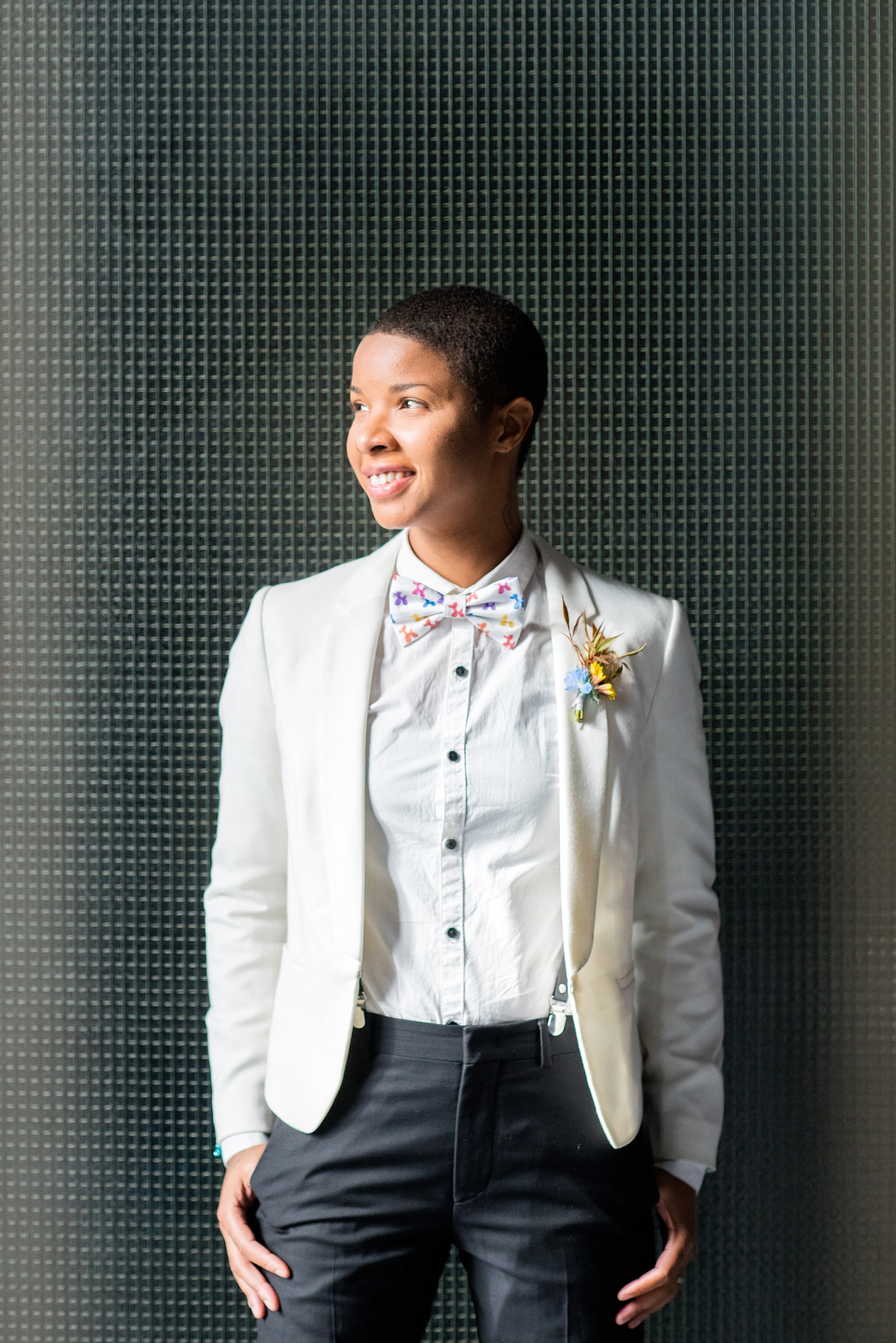 Mikkel Paige Photography photos of a wedding at the Green Building in Brooklyn, New York. This same sex, gay marriage styled shoot was created by Color Pop Events. The model wore a white jacket and white shirt with black buttons and Jeff Koons blue balloon animal cufflinks. They wore a balloon animal bow tie to match.